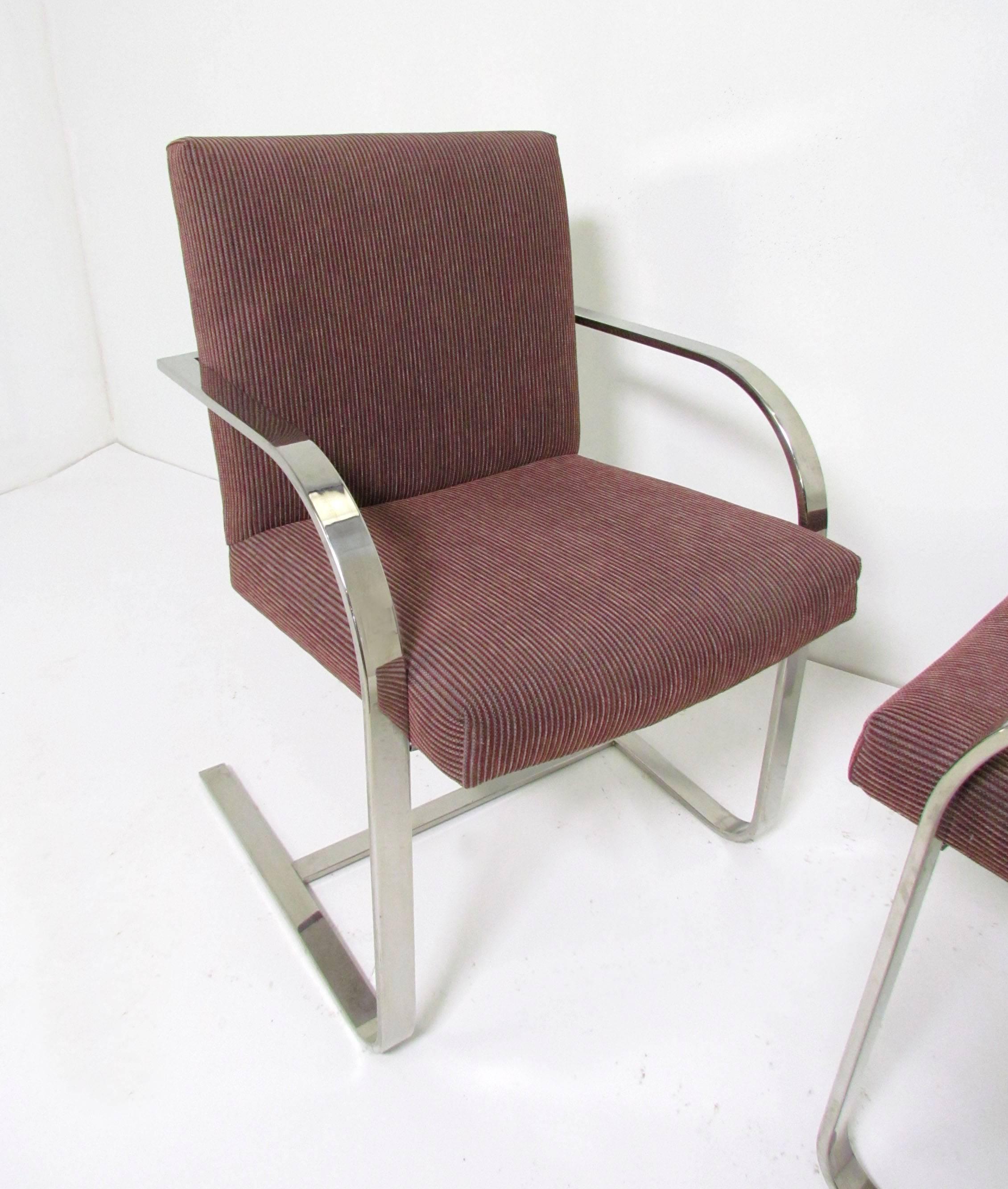 Set of four flat bar chrome cantilever chairs, in the style of Mies van der Rohe's iconic Brno chairs. This set with chrome back bar, attributed to Brueton, circa 1970s.

Please see our other listings for another set of four in same upholstery