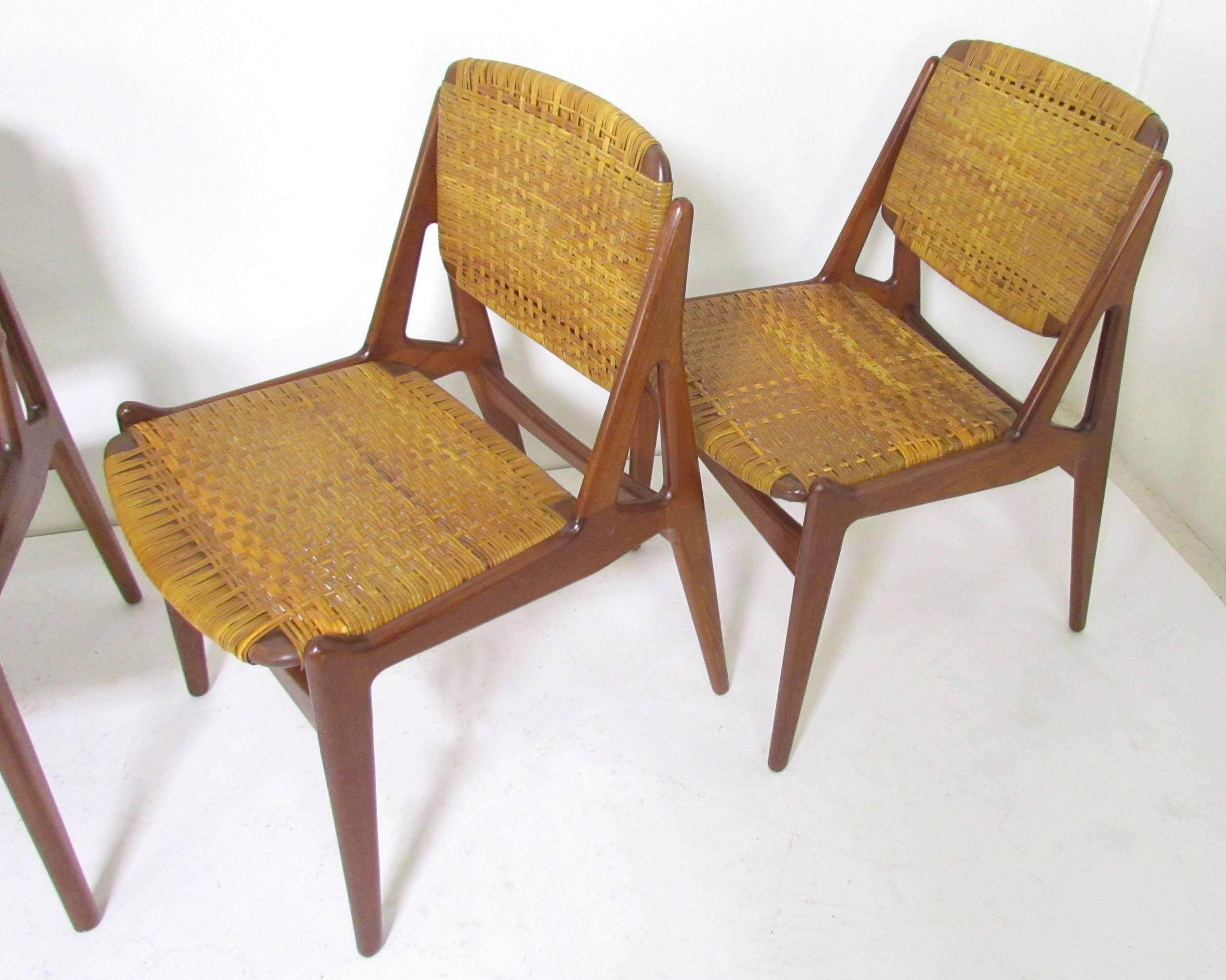 Set of five teak and cane "Ella" dining chairs (four side and one armchair) designed by Arne Vodder for Vamo Mobelfabrik, Denmark, circa 1960s. Extremely comfortable ergonomic design with pivoting seat backs that conform to sitter's