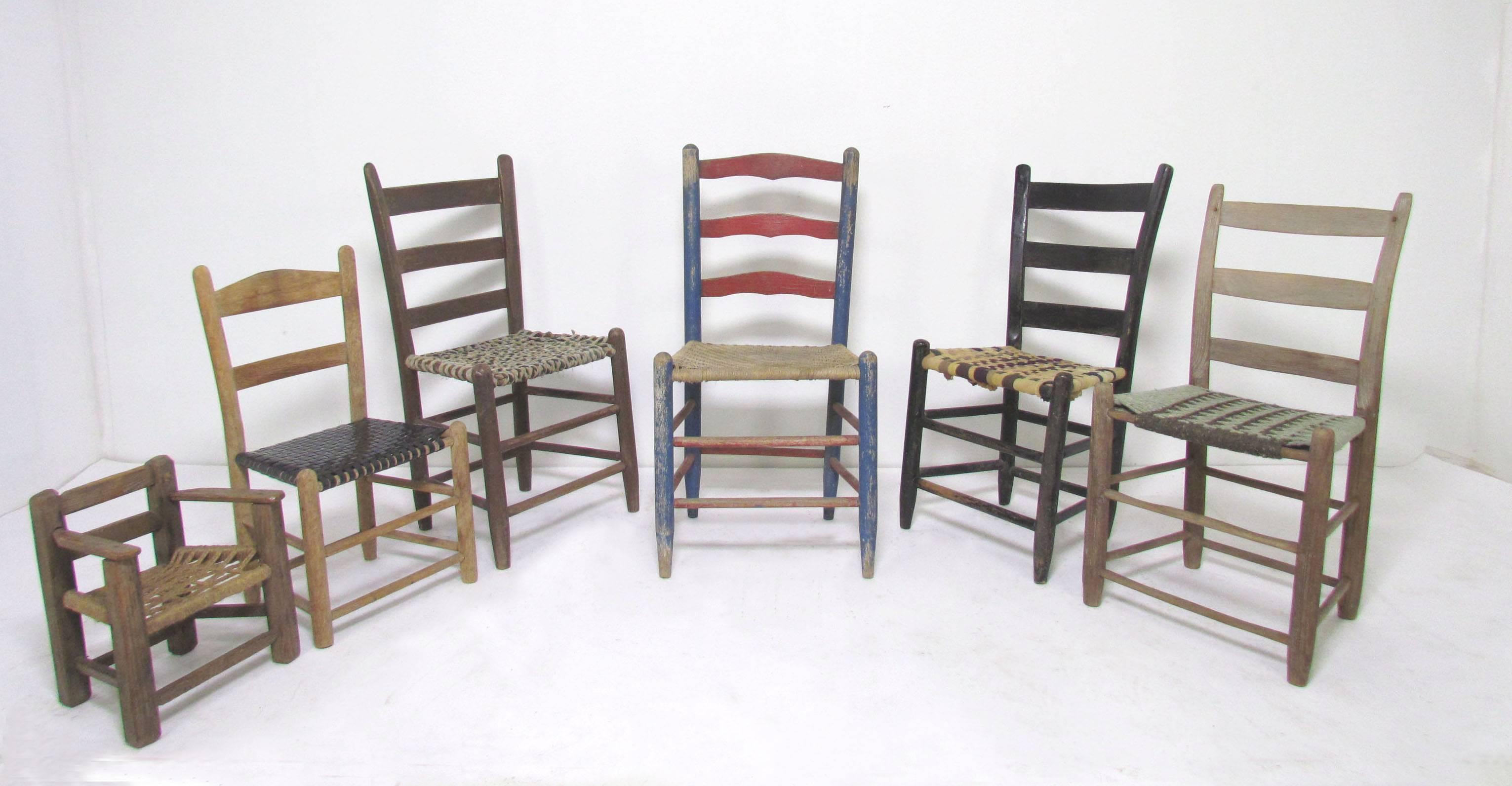 A charming collection of six Primitive 19th century Folk Art chairs in various sizes, and styles. Some in weathered wood, others in original old paint, with handwoven seats of fabric and various fibers. Each a singular work of art.

Largest