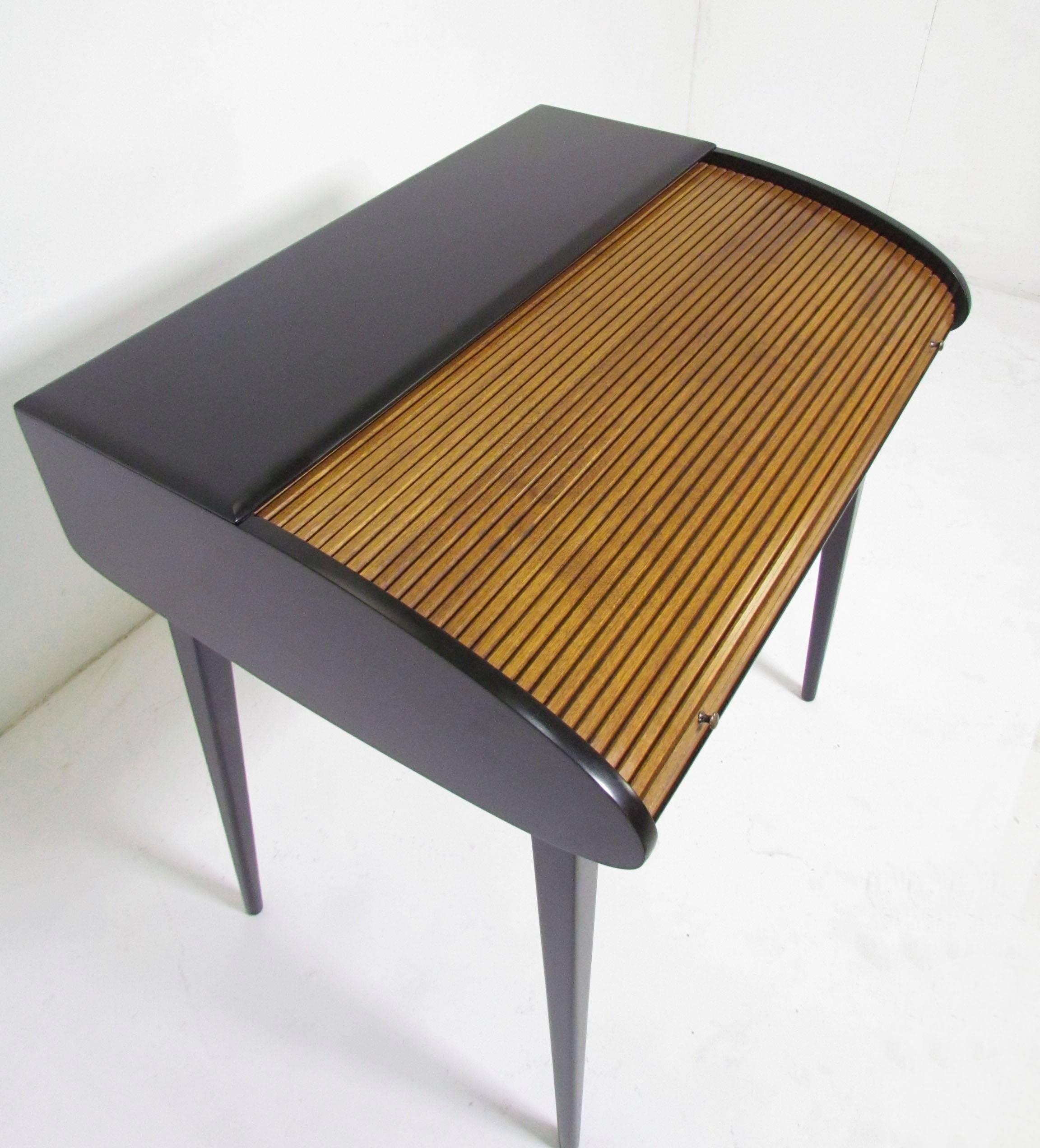 Roll top desk by Heywood Wakefield, circa 1960s. The sleek modernist form, clearly influenced by Italian design of the late 1950s, was a departure from the typical bulky prewar concepts most often associated with this venerable American
