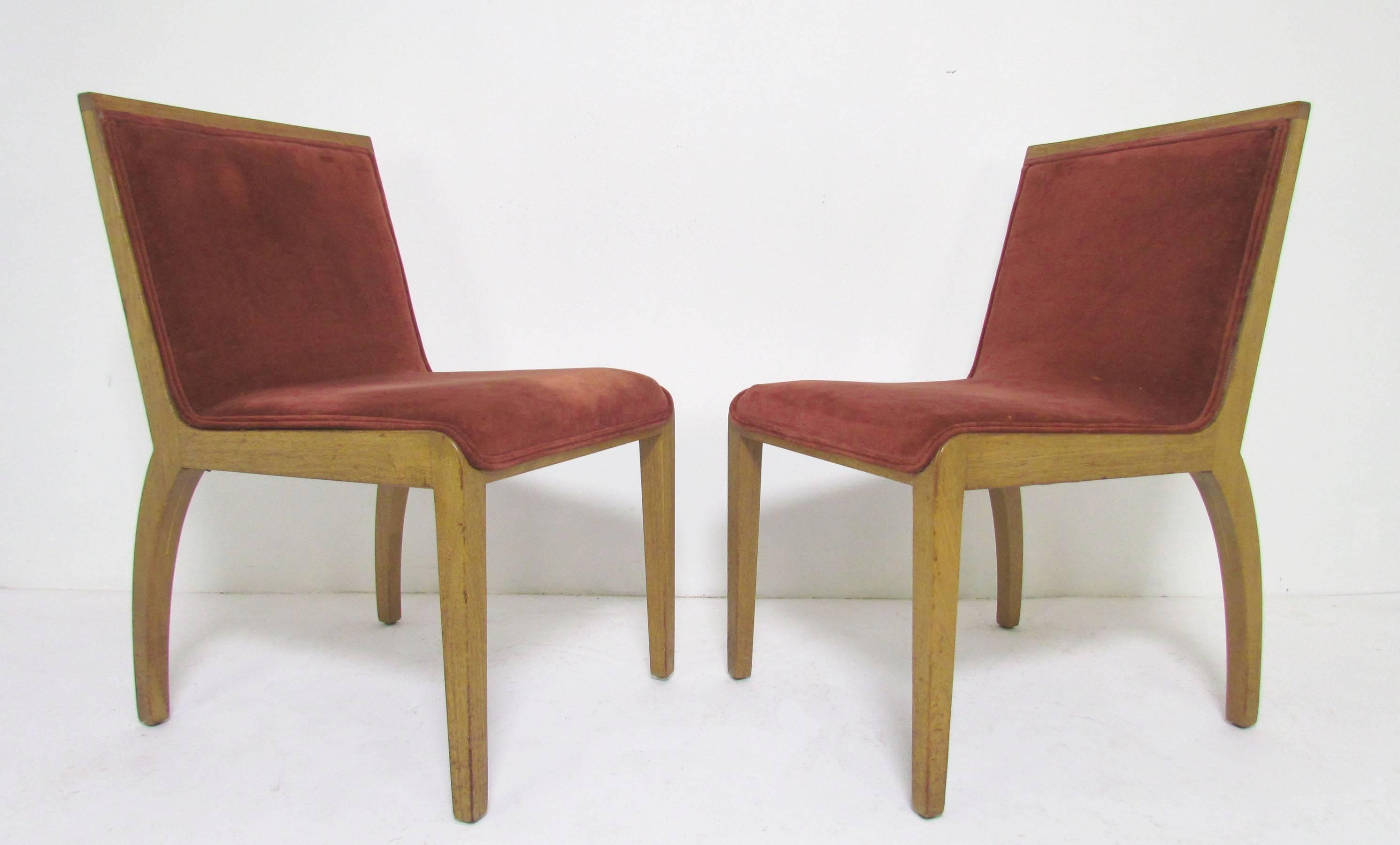 Set of four dining chairs in bleached mahogany by Edward Wormley for Dunbar, circa 1950, featuring full wooden back panels and elegantly canted legs. A quite rare model, among Wormley's earliest designs for Dunbar.