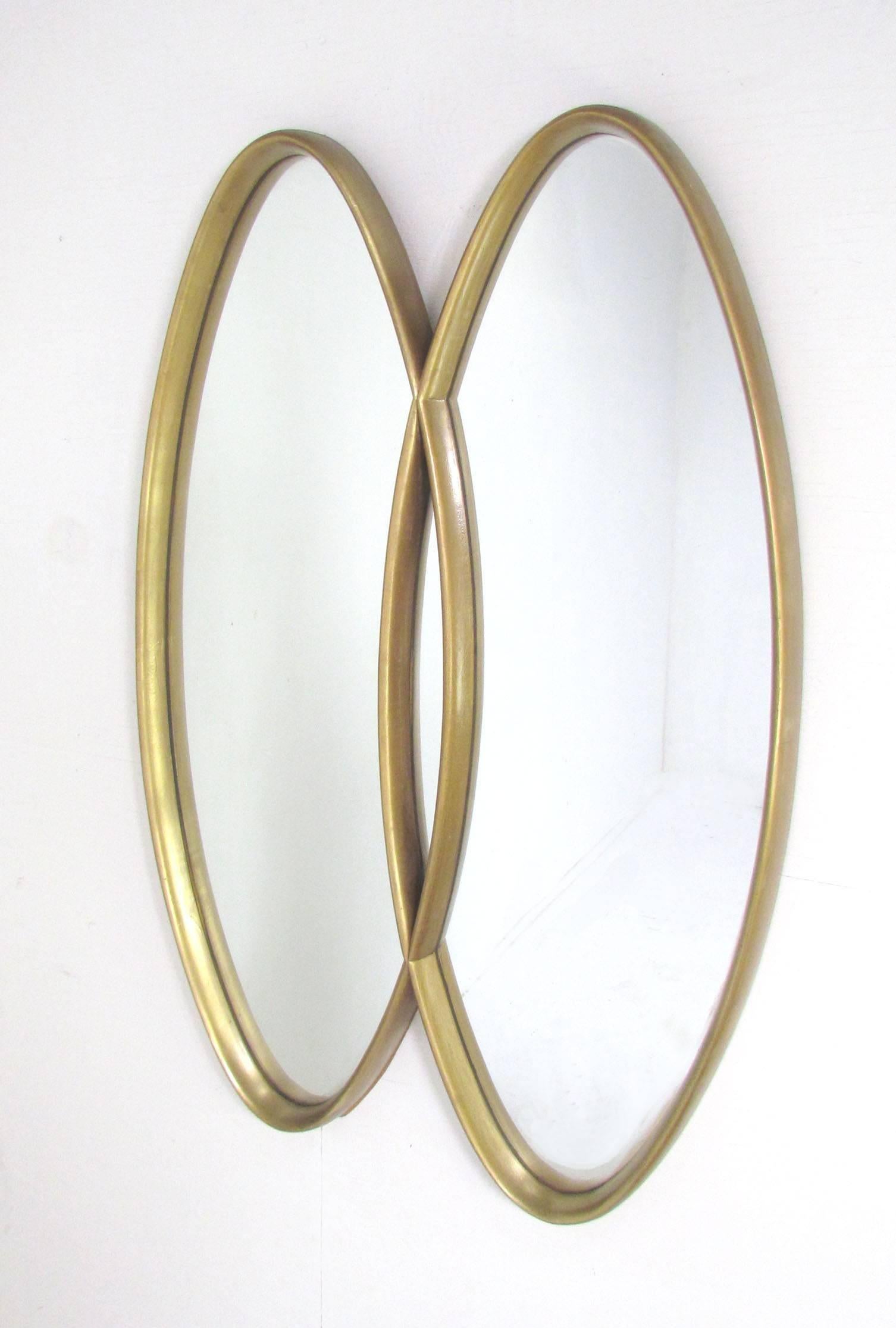 Impressive giltwood wall mirror consisting of two interlocking ovals, circa 1950s, most likely by La Barge.