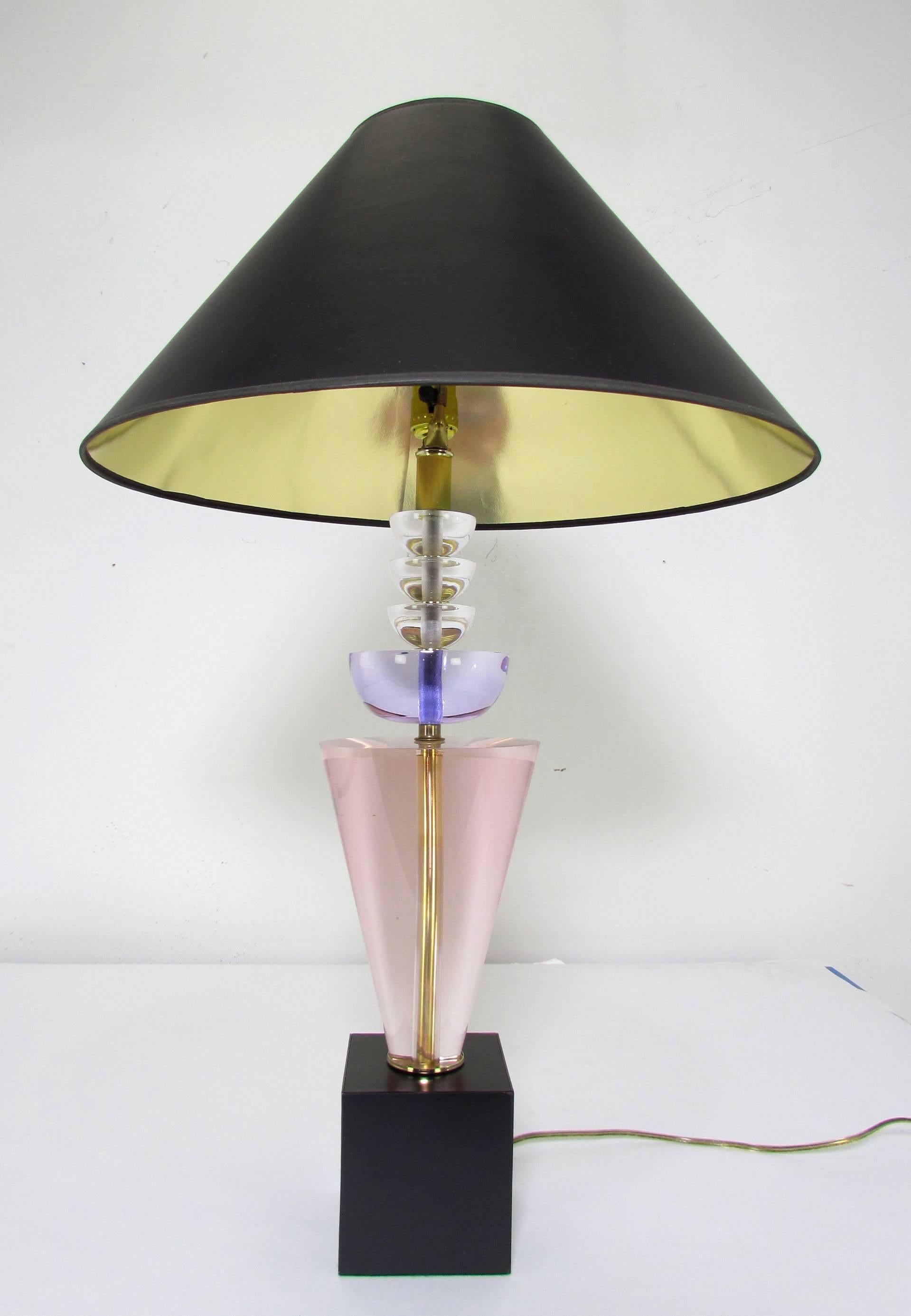 Pair of stacked Lucite table lamps by Hivo Van Teal, in purple, pink and clear elements, original Lucite ball finials and black shades with gold foil lining.

Lamps measure 31.5