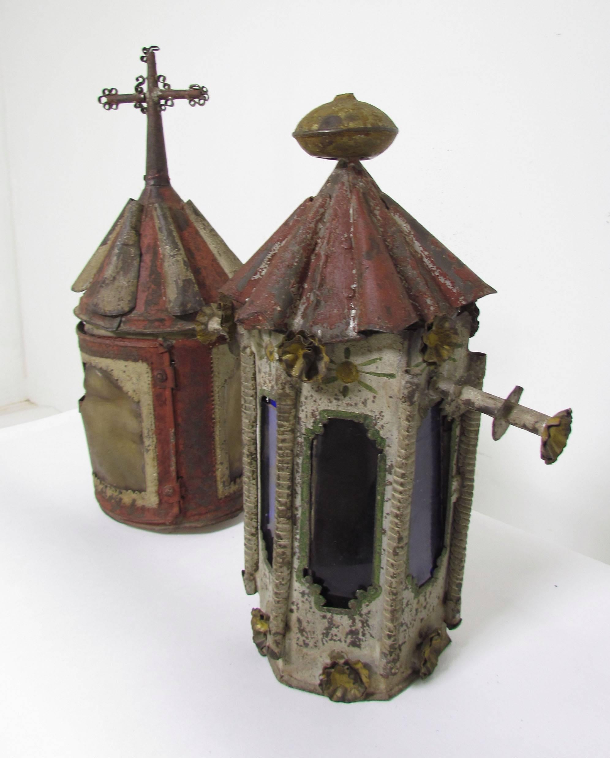 Two antique ca. late 19th century polychrome Mexican processional lanterns, one with sheepskin vellum shade, the other with colored glass panels.

One measures 17