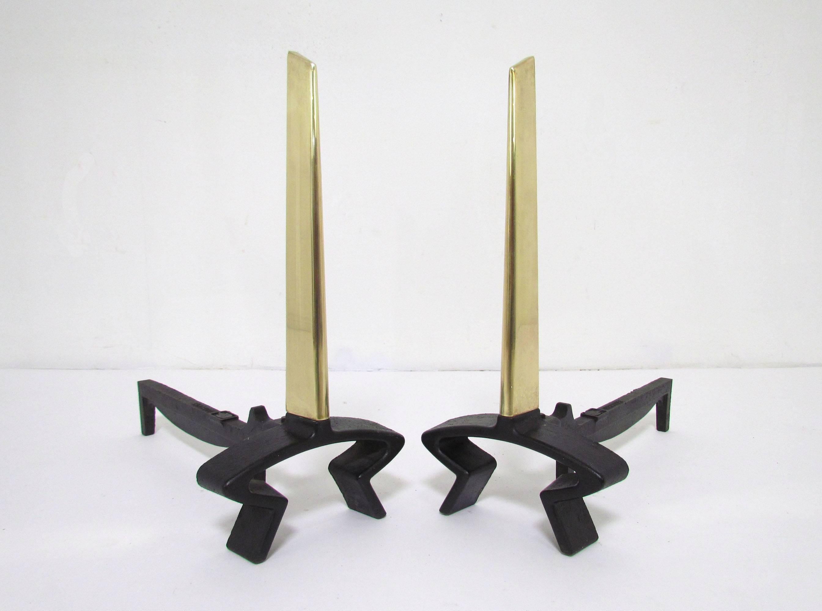 Pair of modernist andirons in brass and iron, designed by Donald Deskey for Bennett, circa 1950s.