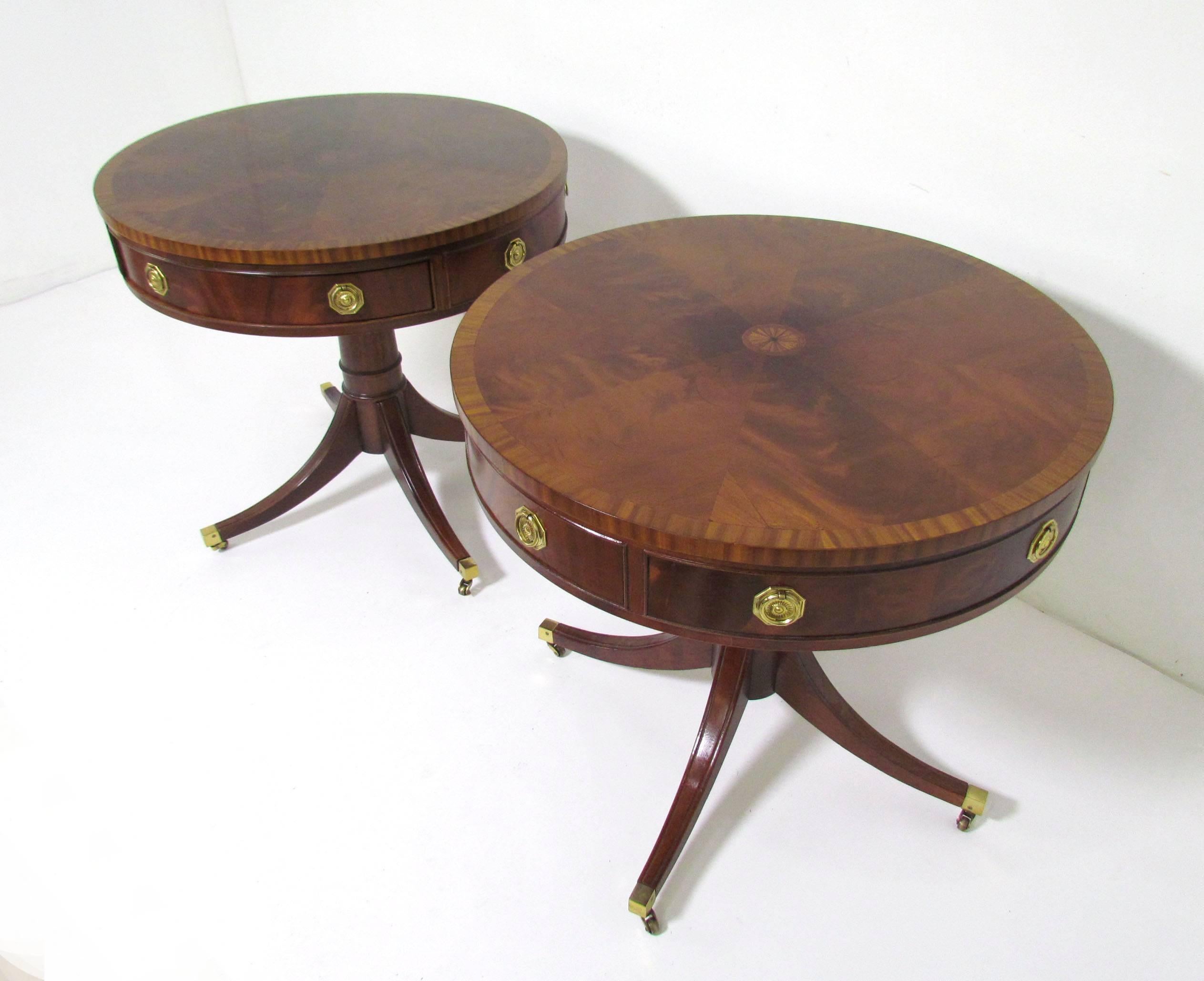 Pair of pedestal drum tables from the historic James River collection by Hickory Chair, circa 1980s. Each with a single drawer. Extremely high level of craftsmanship in these pieces. With crotch mahogany top and solid brass hardware.