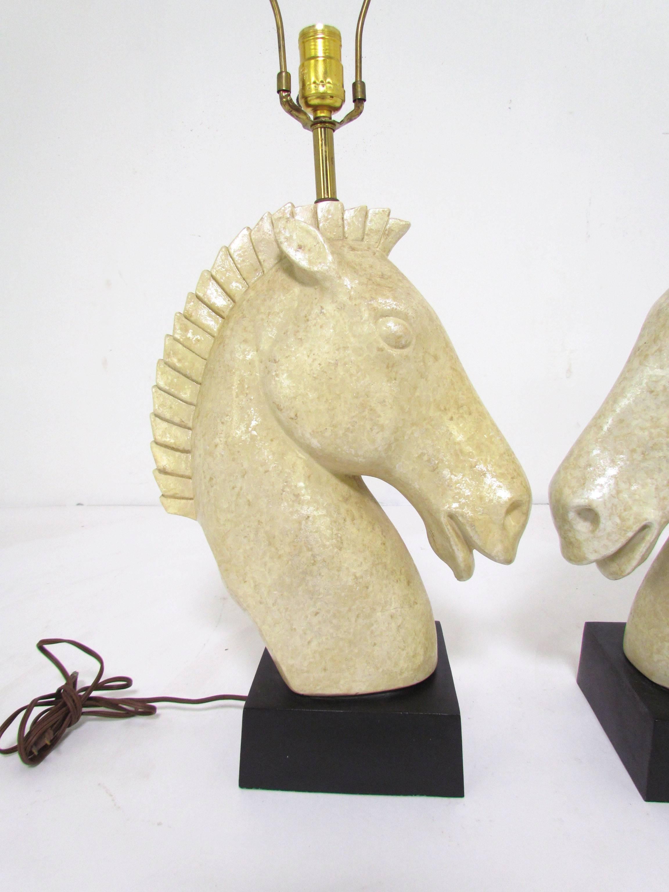 Pair of horse head table lamps, signed Fortune Lamp Co. and dated 1961. Pearlescent glaze over chalk ware.

Height to top of finials is 30