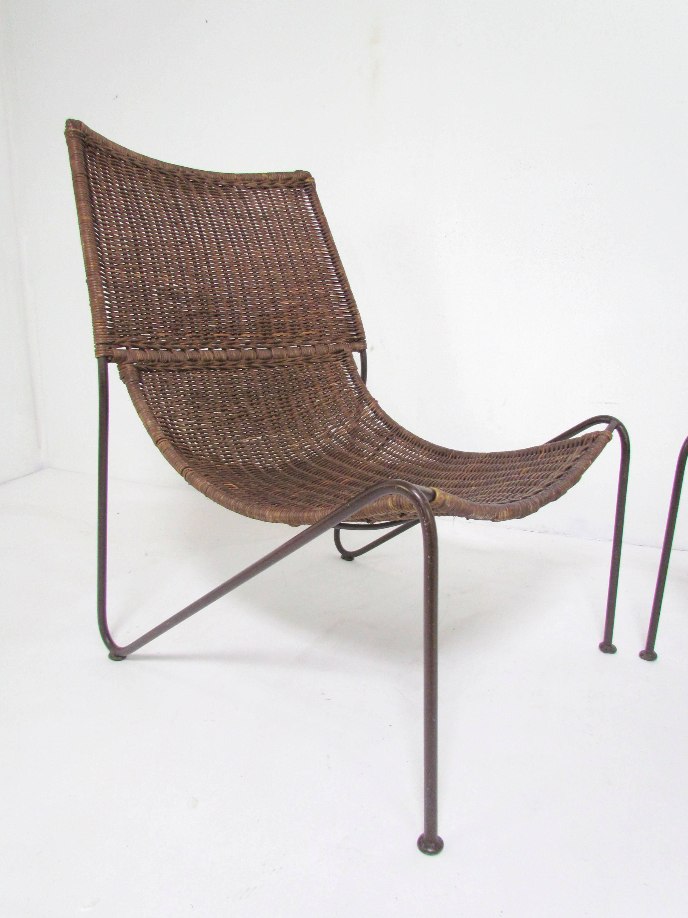 Pair of stylish lounge chairs in woven rattan and steel. Owing to their timeless design and surprisingly high degree of craftsmanship, these are often mis-attributed to Van Keppel and Green, Frederic Weinberg, and even Arthur Umanoff. Produced in