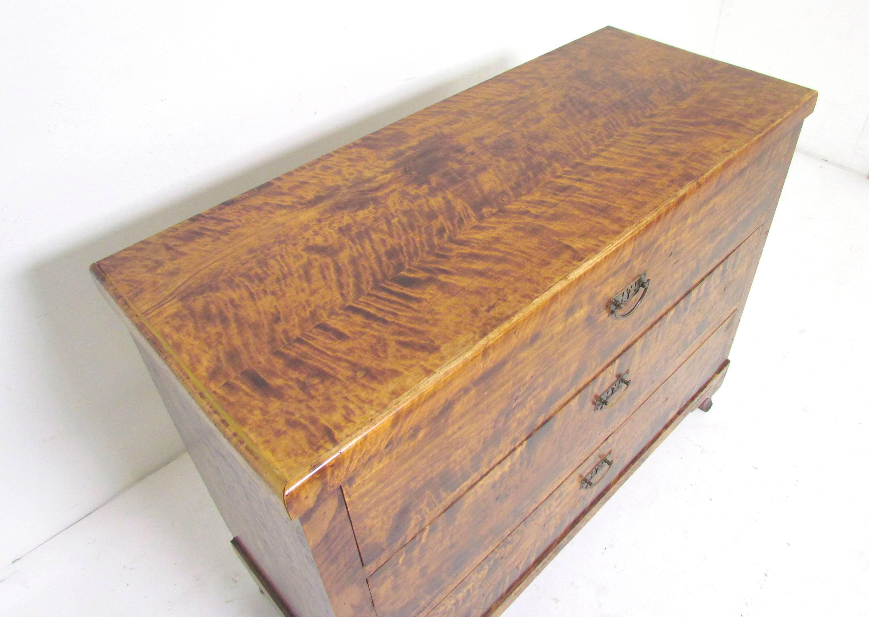 A very refined Louis Philippe period commode or three-drawer chest in tiger grained maple, circa 1830s.