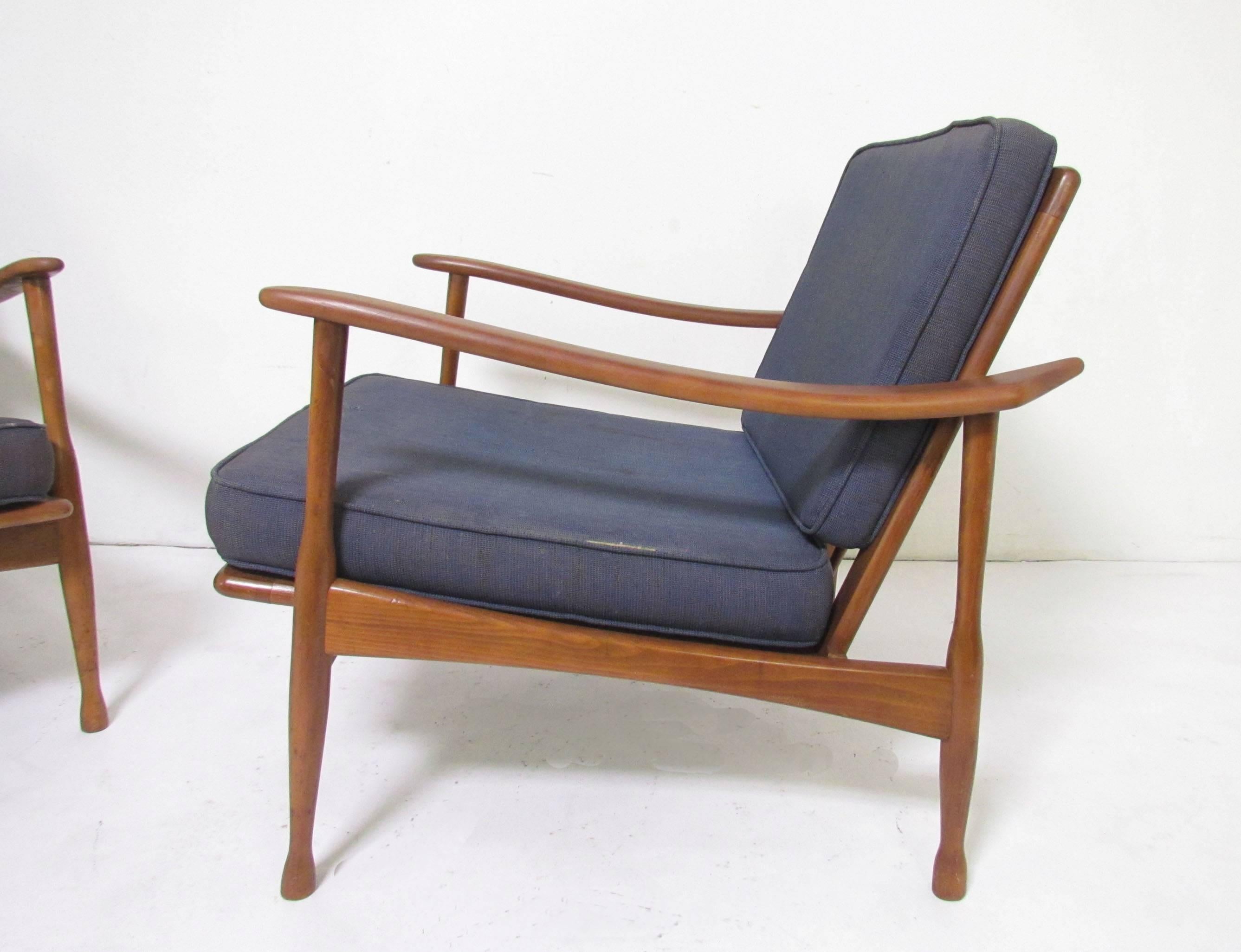 Pair of Mid-Century lounge chairs in the Danish modern style, but with an Italian flair. Upswept armbacks and gracefully turned legs. Stamped "Made in Italy".

         