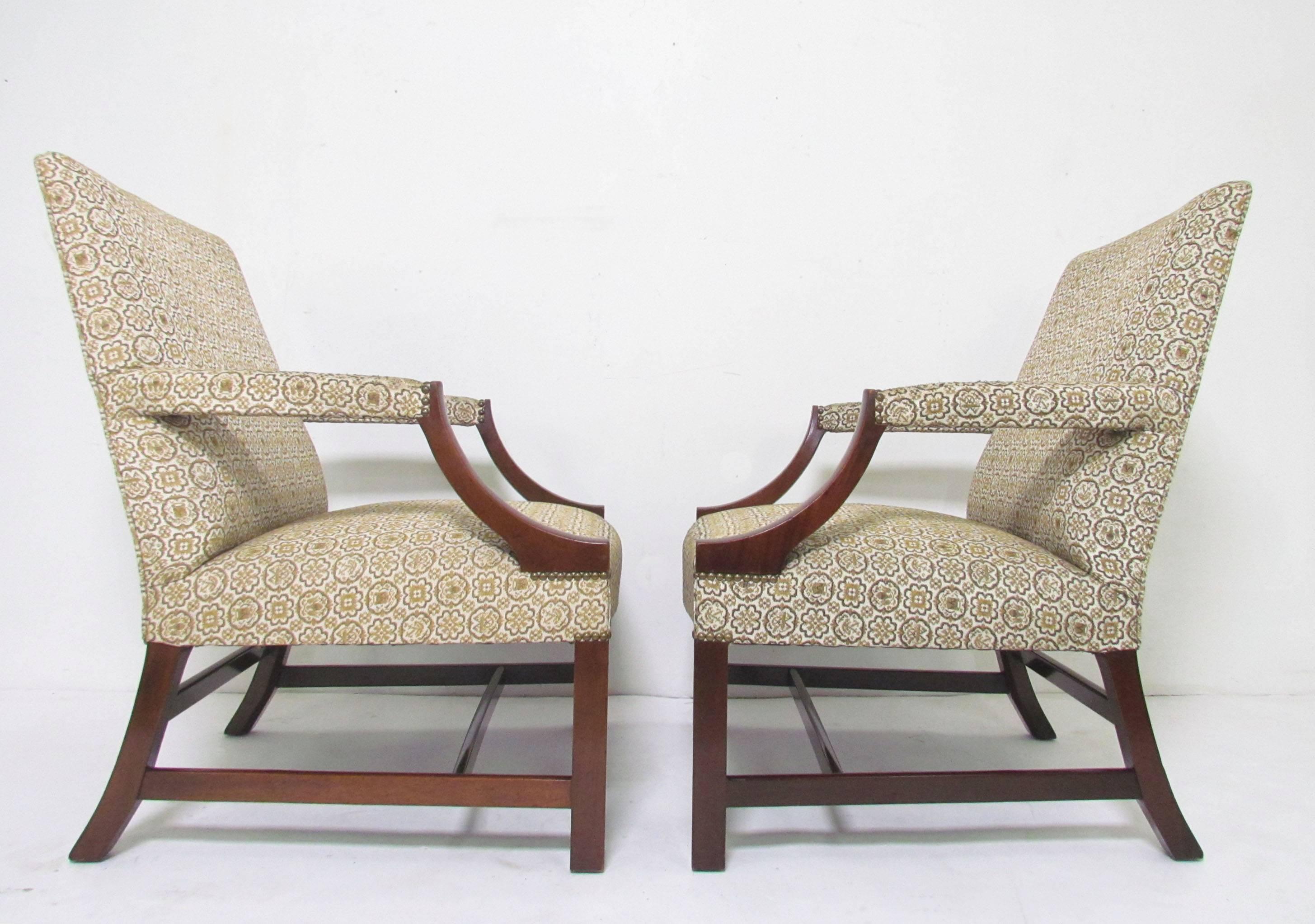 Pair of open-arm lounge chairs by Baker Furniture in the style of a George III Gainsborough chair (also known as a Martha Washington chair).