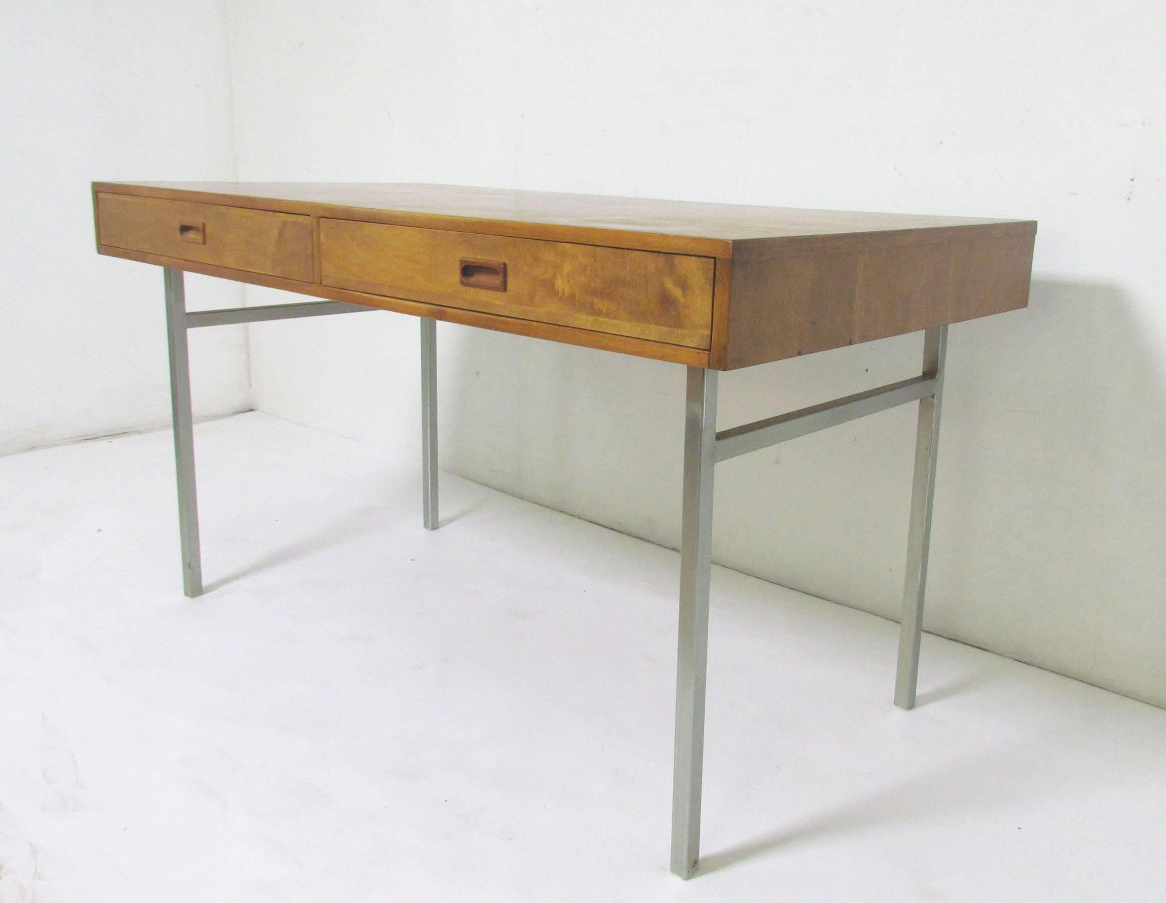 Sleek modernist two-drawer desk in walnut on steel legs, circa 1970s. Most likely custom-made.