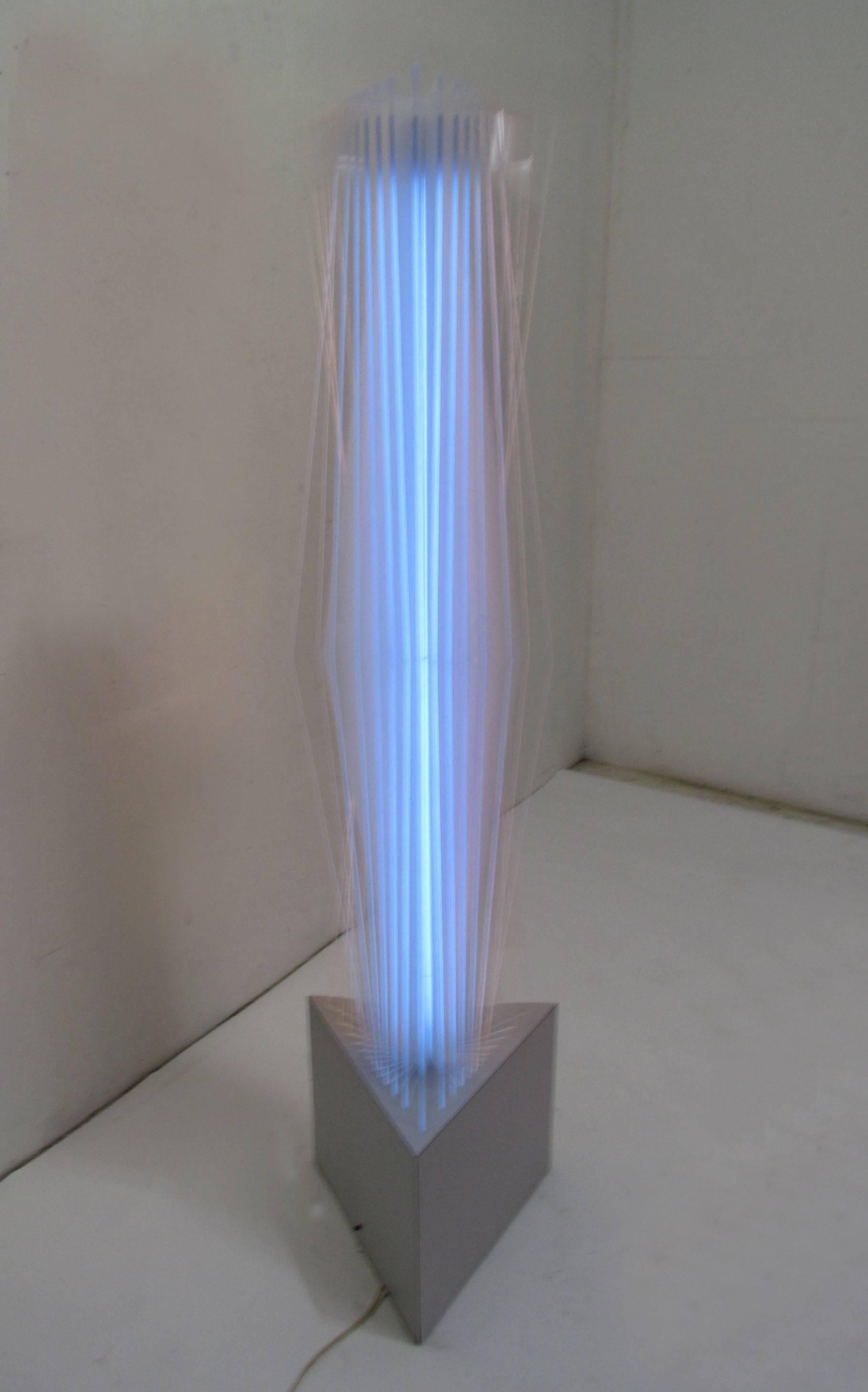 From the Long Island estate of the noted New York sculptor Norman Mercer, a neon light sculpture consisting of panels of clear Lexan radiating from interior tubes of blue and pink mounted on a triangular base, circa 1980s, this piece once decorated