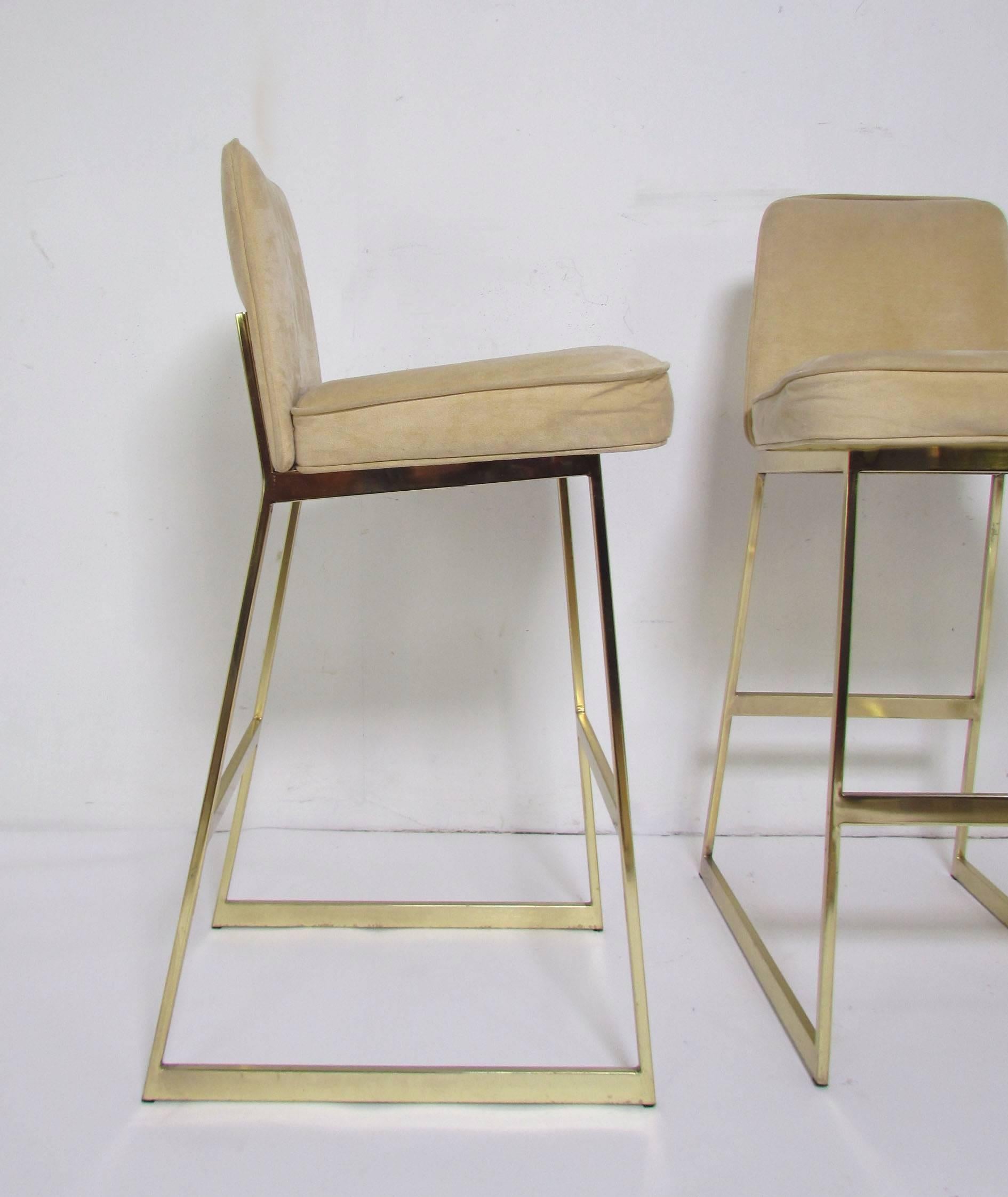 Set of three brass bar stools by Tri-Mark, circa 1970s. Tri-Mark was a Philadelphia furniture company which produced high quality modern designs which were heavily influenced by the major High Point N.C. makers. These stools are attributed to James