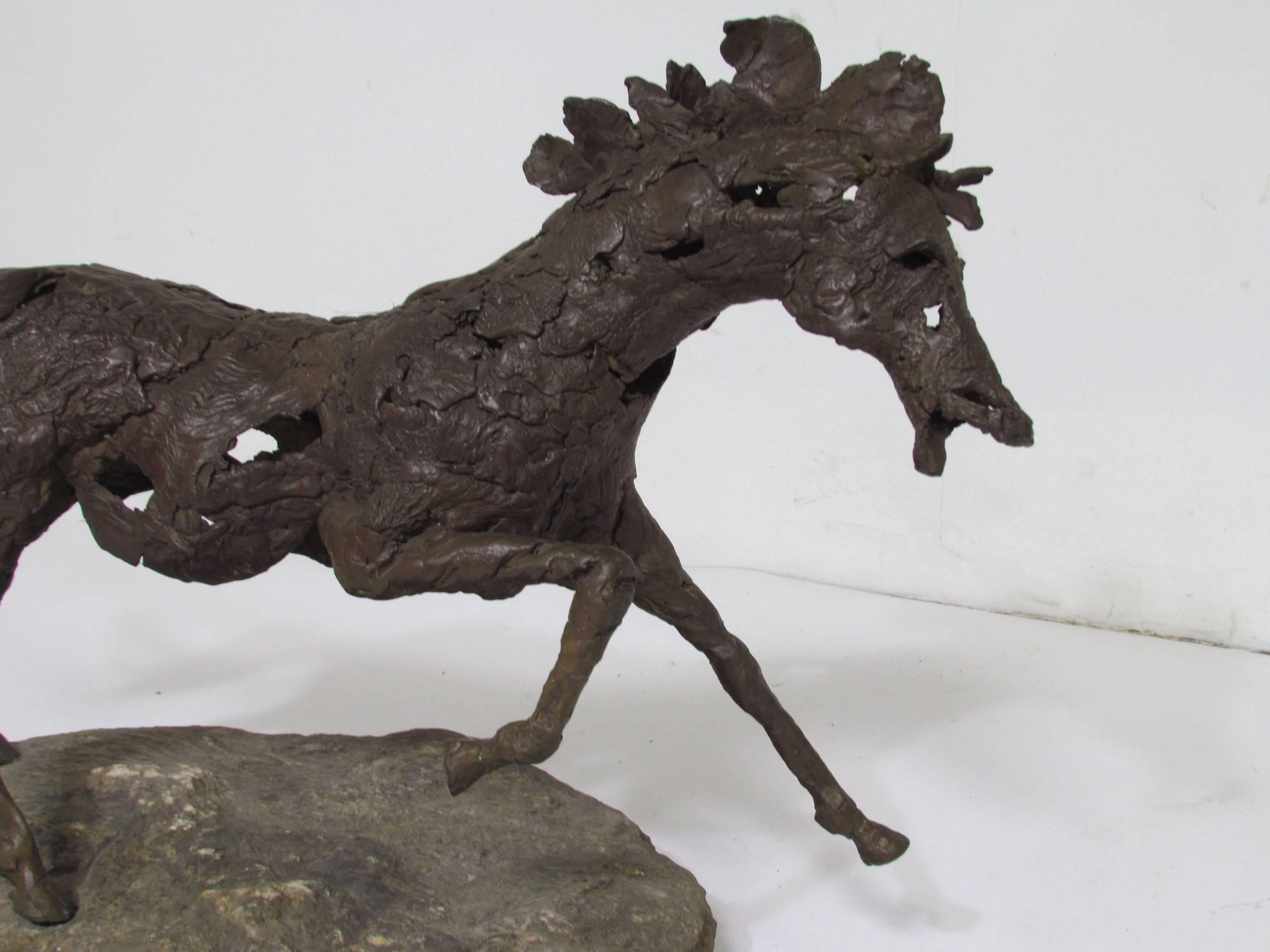 A fluid and dynamic modernist bronze of a horse in stride, mounted on a limestone slab, circa 1960s. Unsigned but masterful work with fine detail.