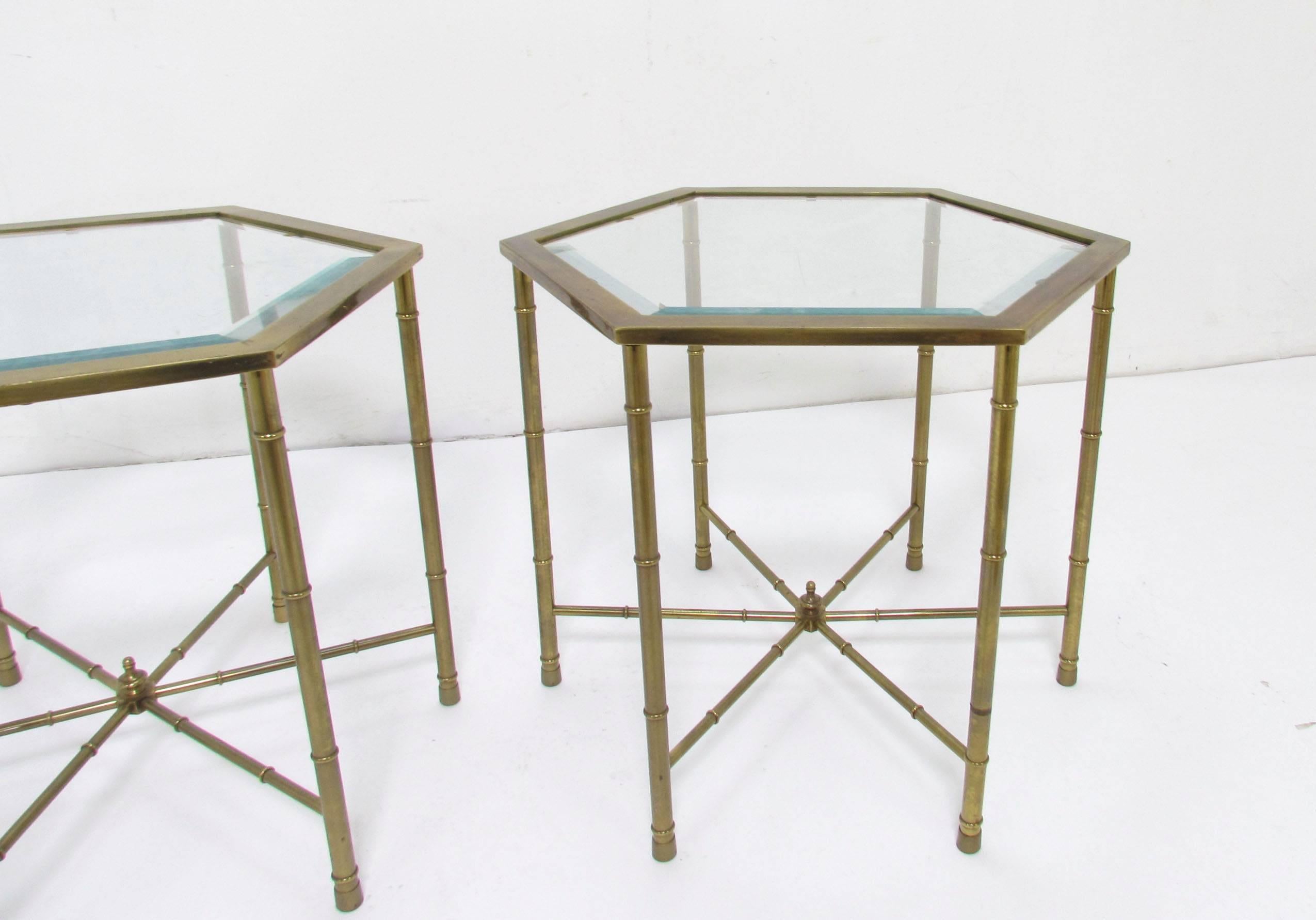 Pair of Hollywood Regency style hexagonal side tables in solid brass with beveled glass tops by Mastercraft, circa 1970s.