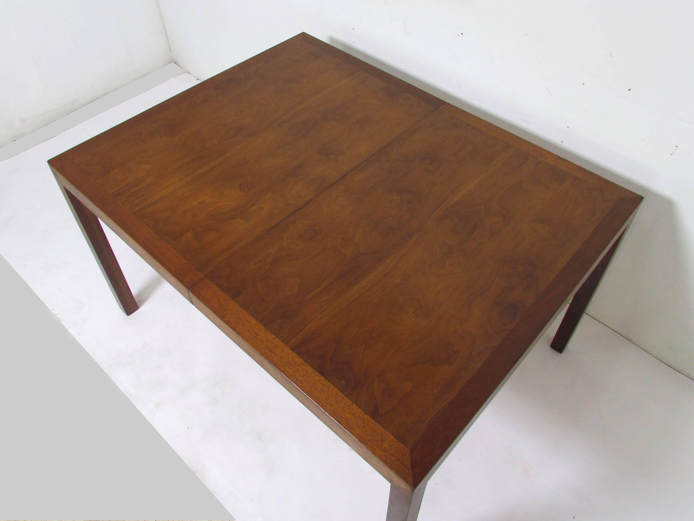 Clean lined midcentury Parsons style dining table in burl wood and mahogany by Edward Wormley for Dunbar, circa 1960s. 

Measures 51.75