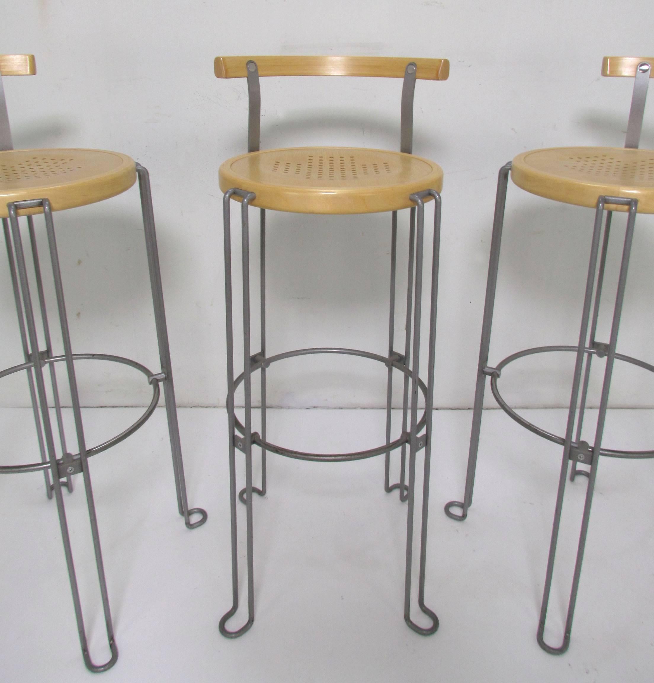 Set of three Postmodern industrial style bar stools in birch and steel designed by Borge Lindau for his company Bla Station. This set, model B4-82, first designed in 1986, was produced in 2003. 

Measures: Seat height is 32.25