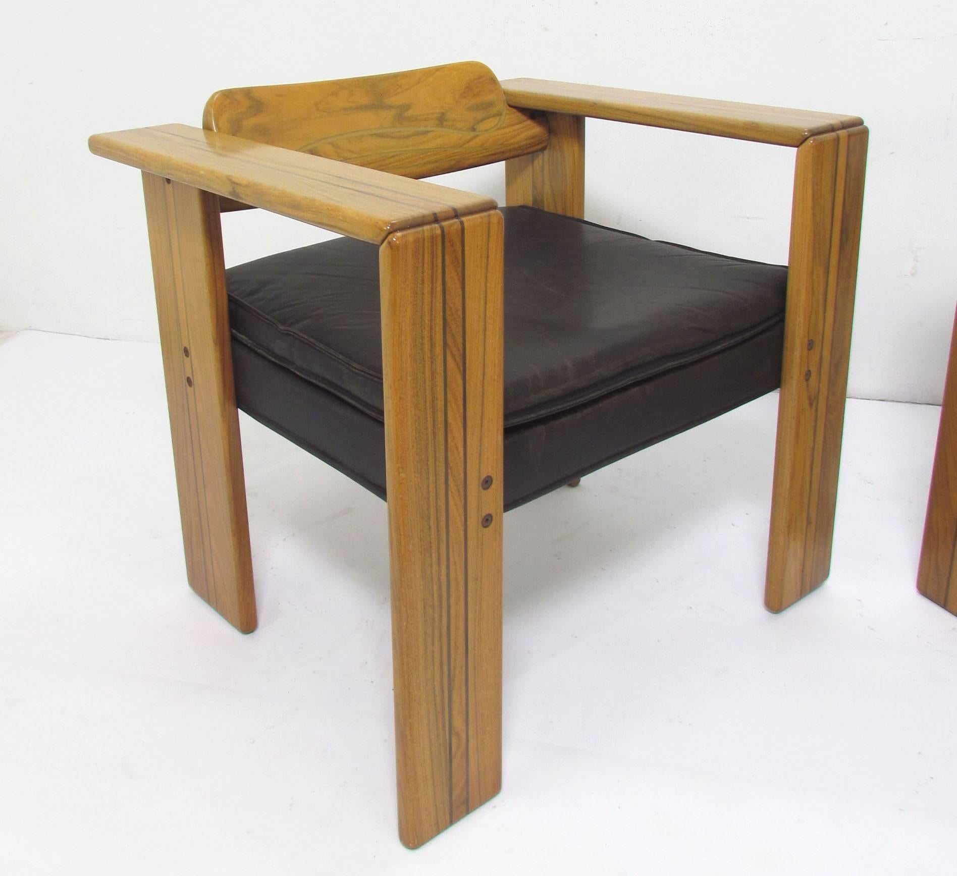 Pair of generously proportioned arm chairs of inlaid walnut, original leather seat cushions, designed by Afra and Tobia Scarpa for the Artona series by Maxalto, Italy, circa 1970s. 

Price is for the pair. 

Measures: Arm height is 25