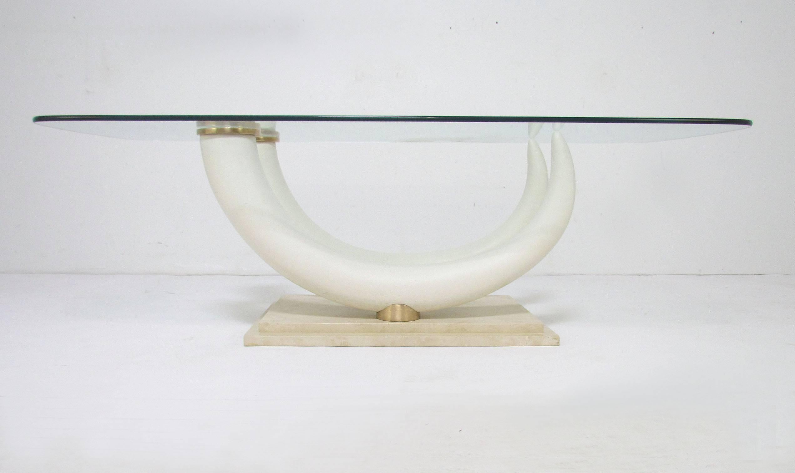 Faux elephant tusk coffee table with brass elements and a travertine base, circa 1970s, by Maison Jansen, made in Italy.