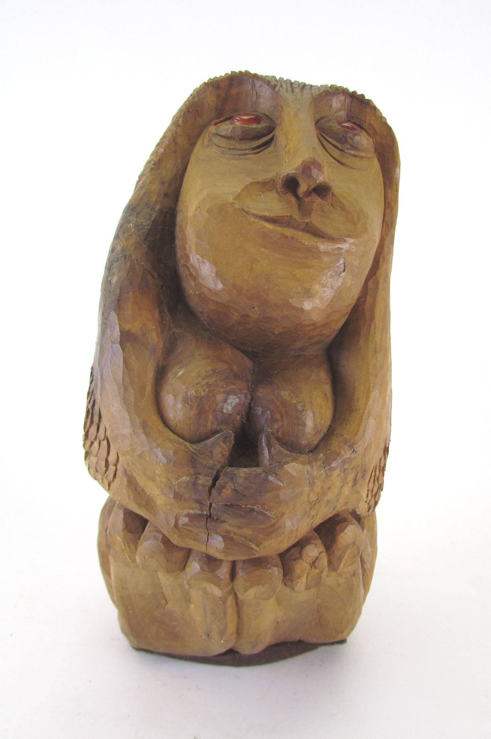 Carved wood sculpture of a female form titled “Apple Mary