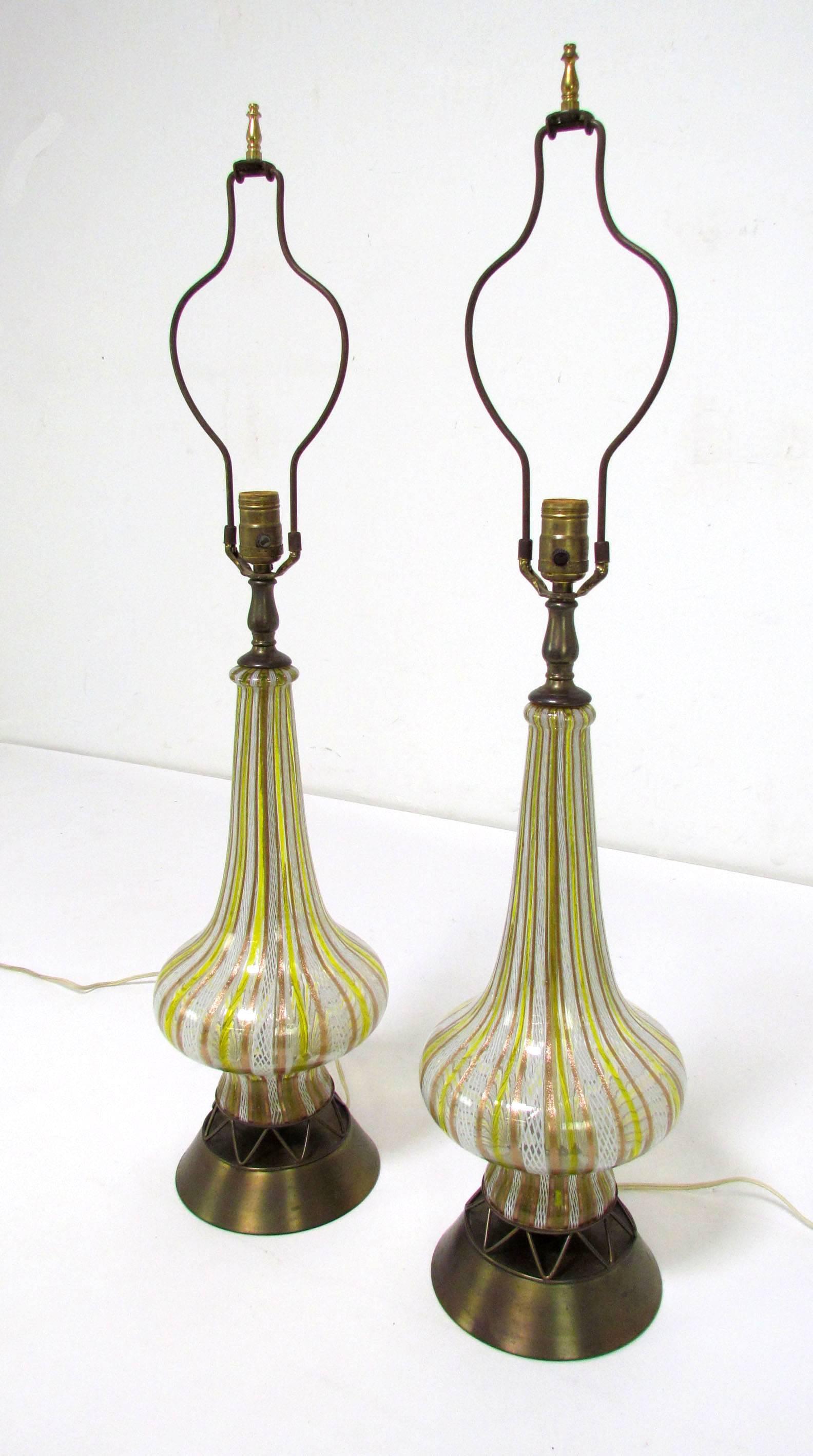 Pair of bottle form Murano glass lamps with zanfirico and latticino decoration, original period mountings, circa 1950s.

Measures: 35.5