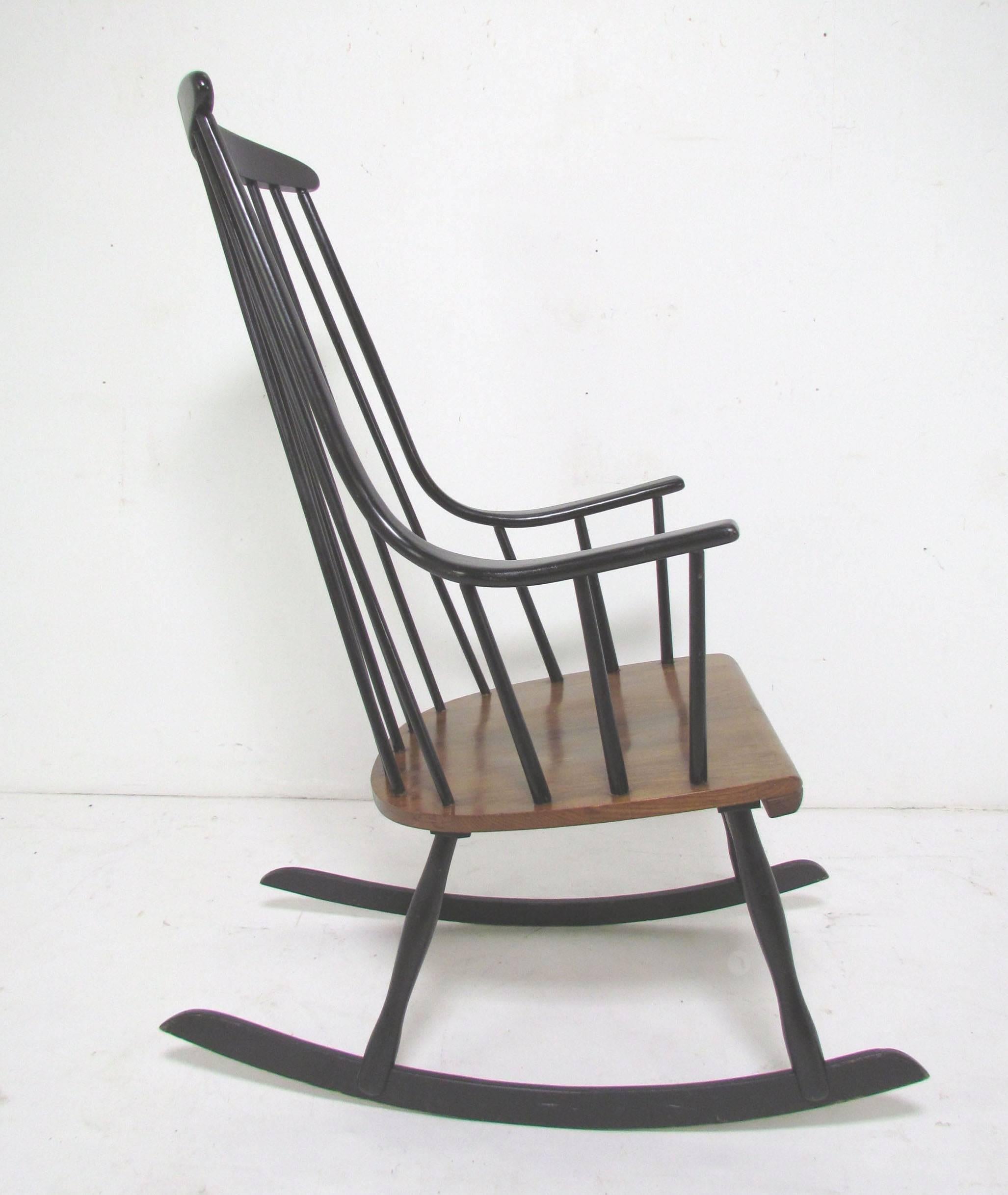Danish Modern rocking chair designed by Lena Larsson, Sweden, circa late 1950s-early 1960s. Original black lacquer finish with contrasting ash seat. This design is often mistakenly attributed to Ilmari Tapiovaara. Very faint maker's mark on