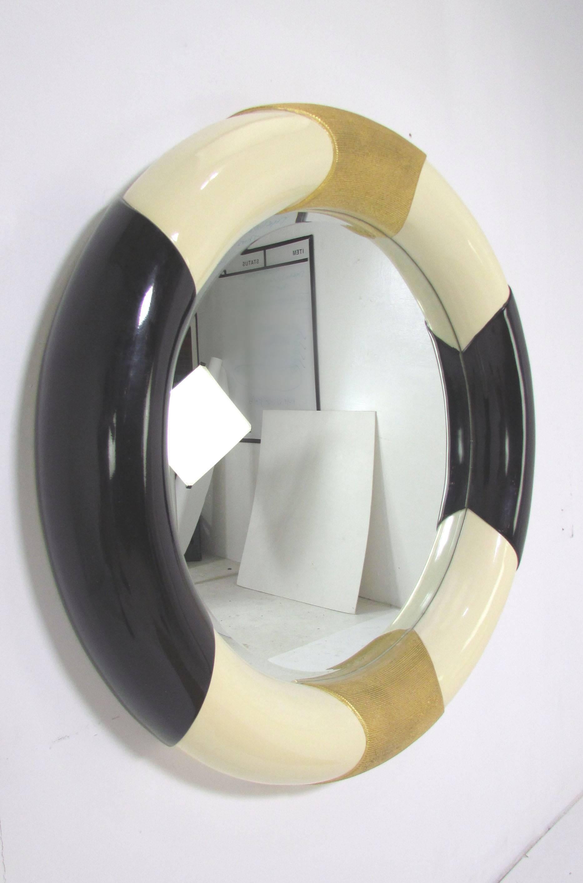 Large wall mirror in ivory and black lacquer with gold accents, circa 1980s.
