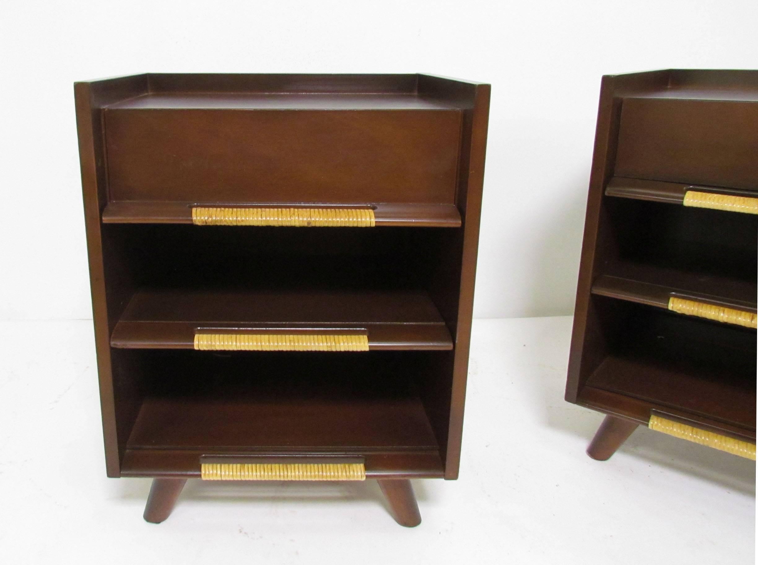 Pair of Mid-Century nightstands with cane wrapped handles, circa 1960s. One drawer over open storage with one adjustable shelf. Handles and drawer construction are so remarkably similar to Edmond Spence's Coronation line for Walpole Furniture that