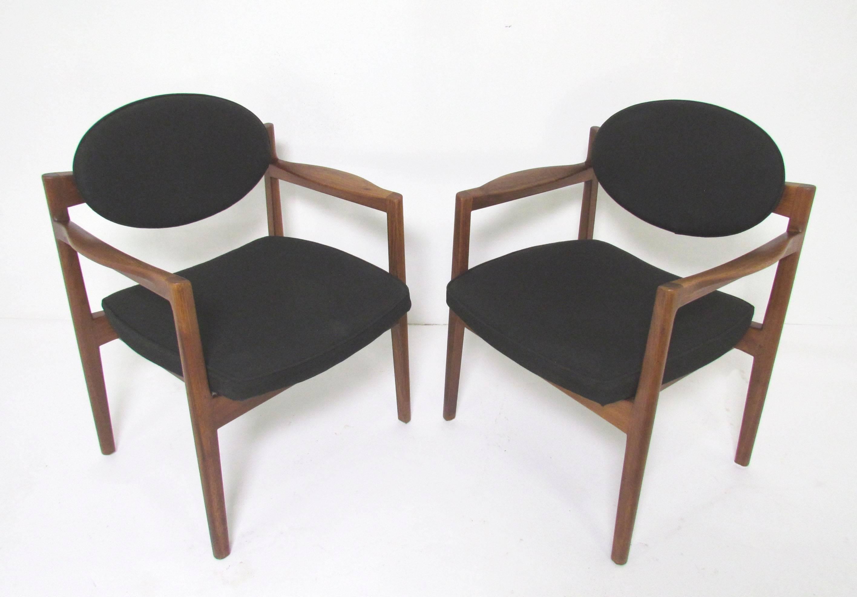 Pair of armchairs in solid walnut, circa 1960s. This model identified by the Danish Museum of Art and Design as a Jens Risom design. Given their size, they can be used as small-scale lounge chairs or as dining chairs, and were paired with a signed