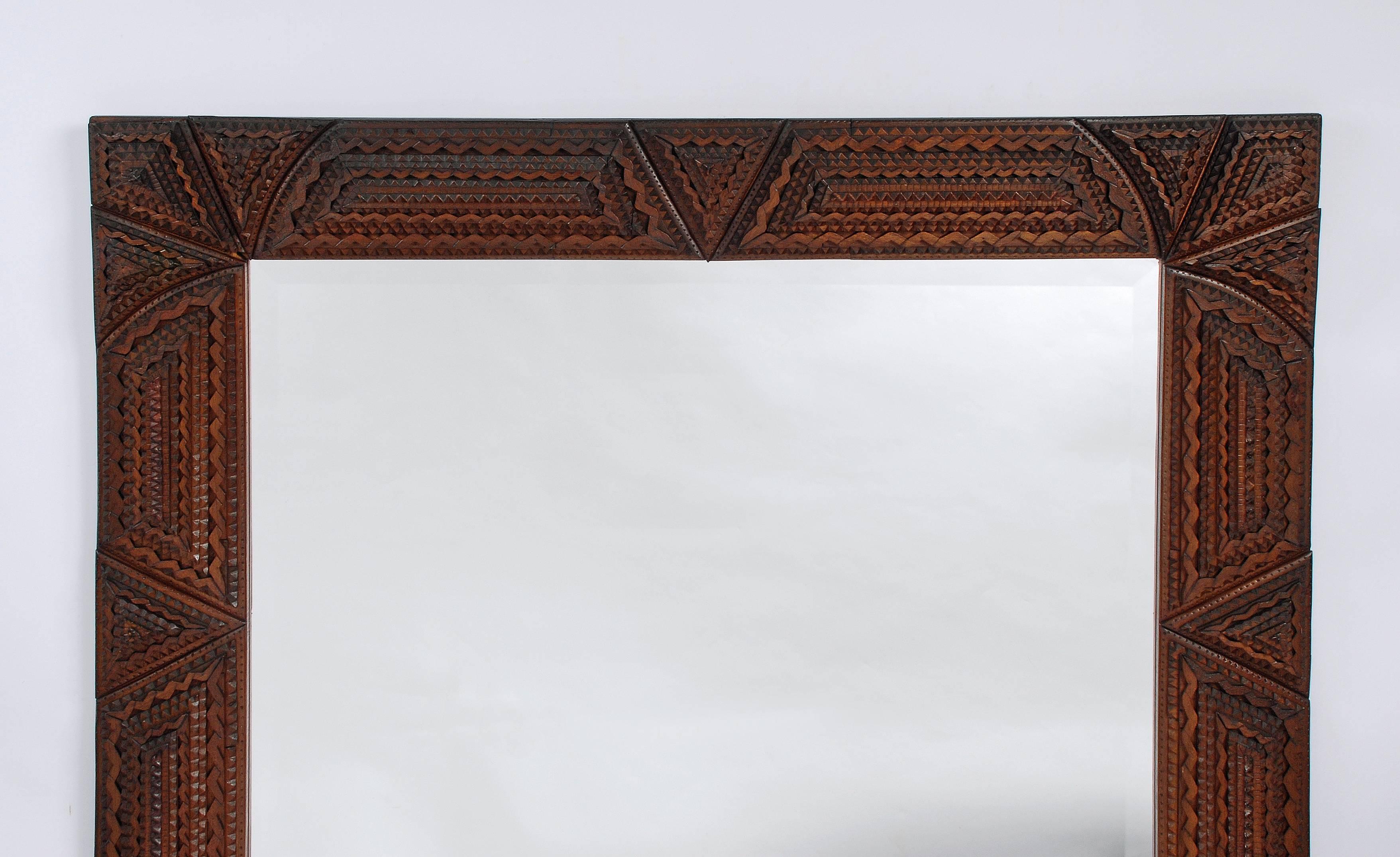 A large and impressive Tramp Art frame with a mounted beveled mirror. Deeply layered and in excellent shape.

Northeast, USA,
circa 1910-1920.