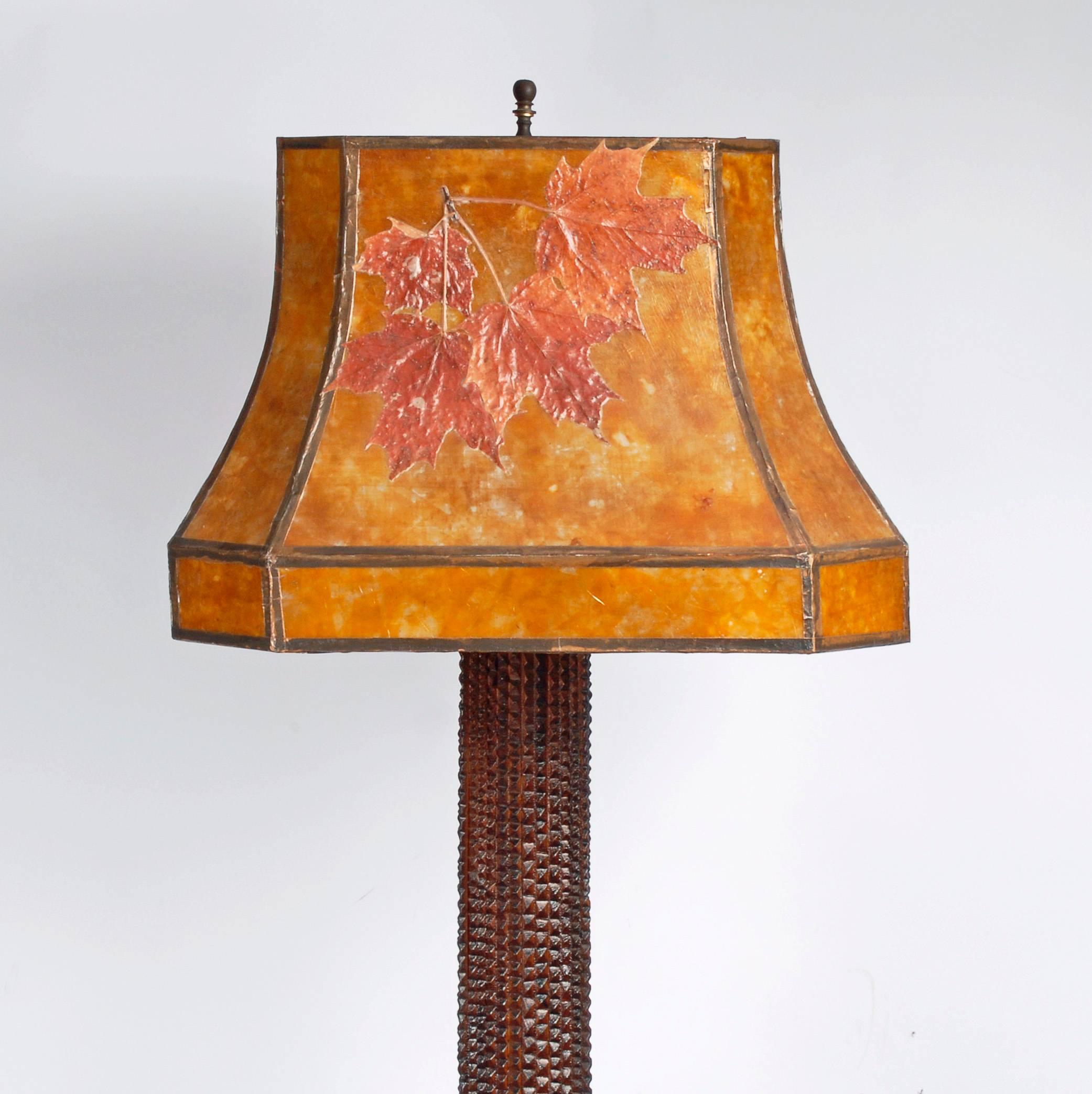 A large elegant Tramp Art floor lamp with a long slender column and a fancy deeply layered footed base that was illustrated in our first book, Tramp Art One Notch at a time on page 154. The floor lamp is among the rarest of forms found in Tramp Art.