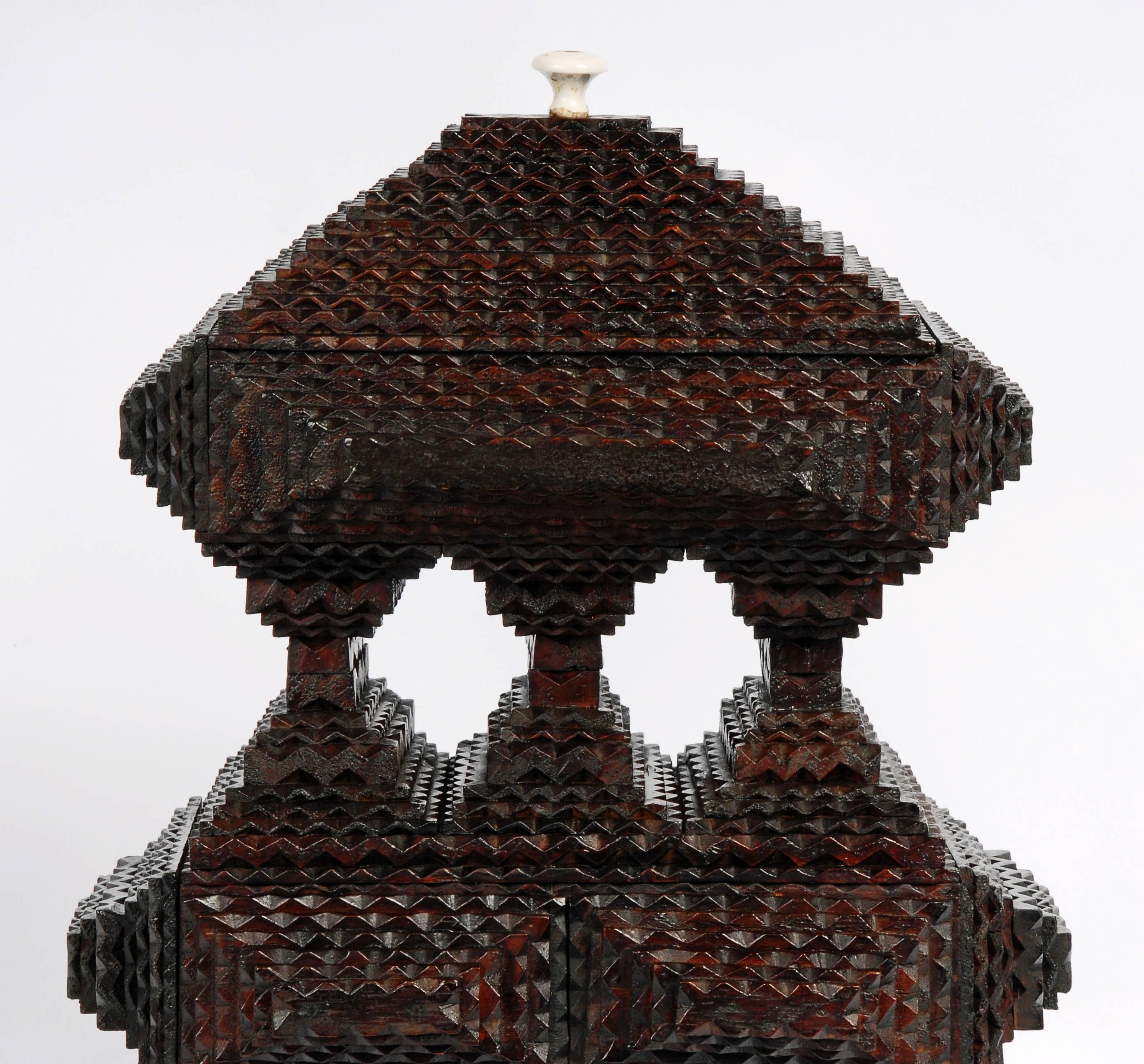 A fine deeply layered Tramp Art pyramidal box with a pedestal base and a three column pedestal middle. This impressive sculpture has a lift-top and a side drawer. 

Found in Scranton, PA,
circa 1880s-1890.