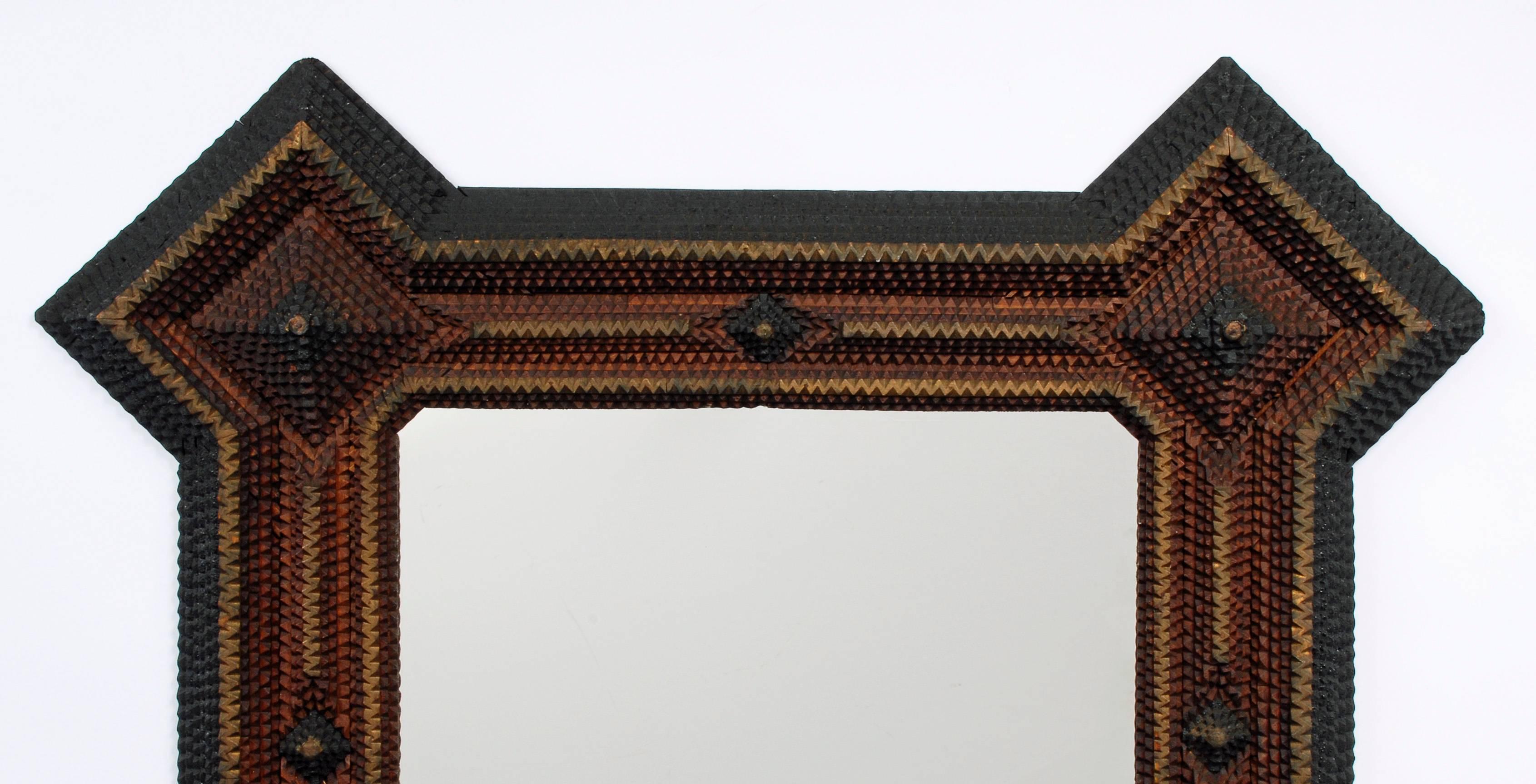 A large three color Tramp Art mirror with extended corners. Large and impressive with deep patterning. 

Found in Auburn, Indiana,
circa 1890s.