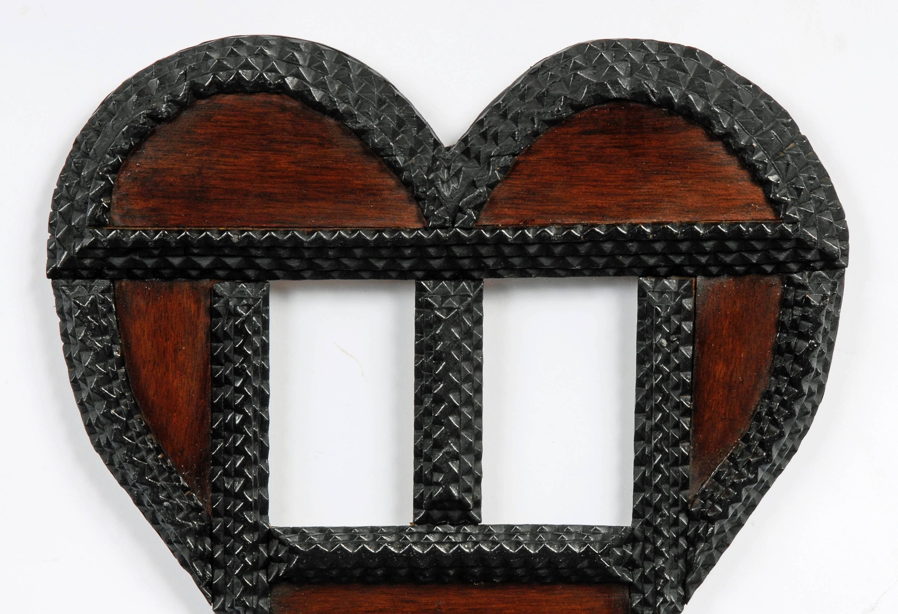 A Tramp Art heart shaped ‘Wedding’ portrait frame. We have had several examples of this style which had photographs of a bride and groom. Although this example is bare with only the original glass covering the openings we believe it held Carte de