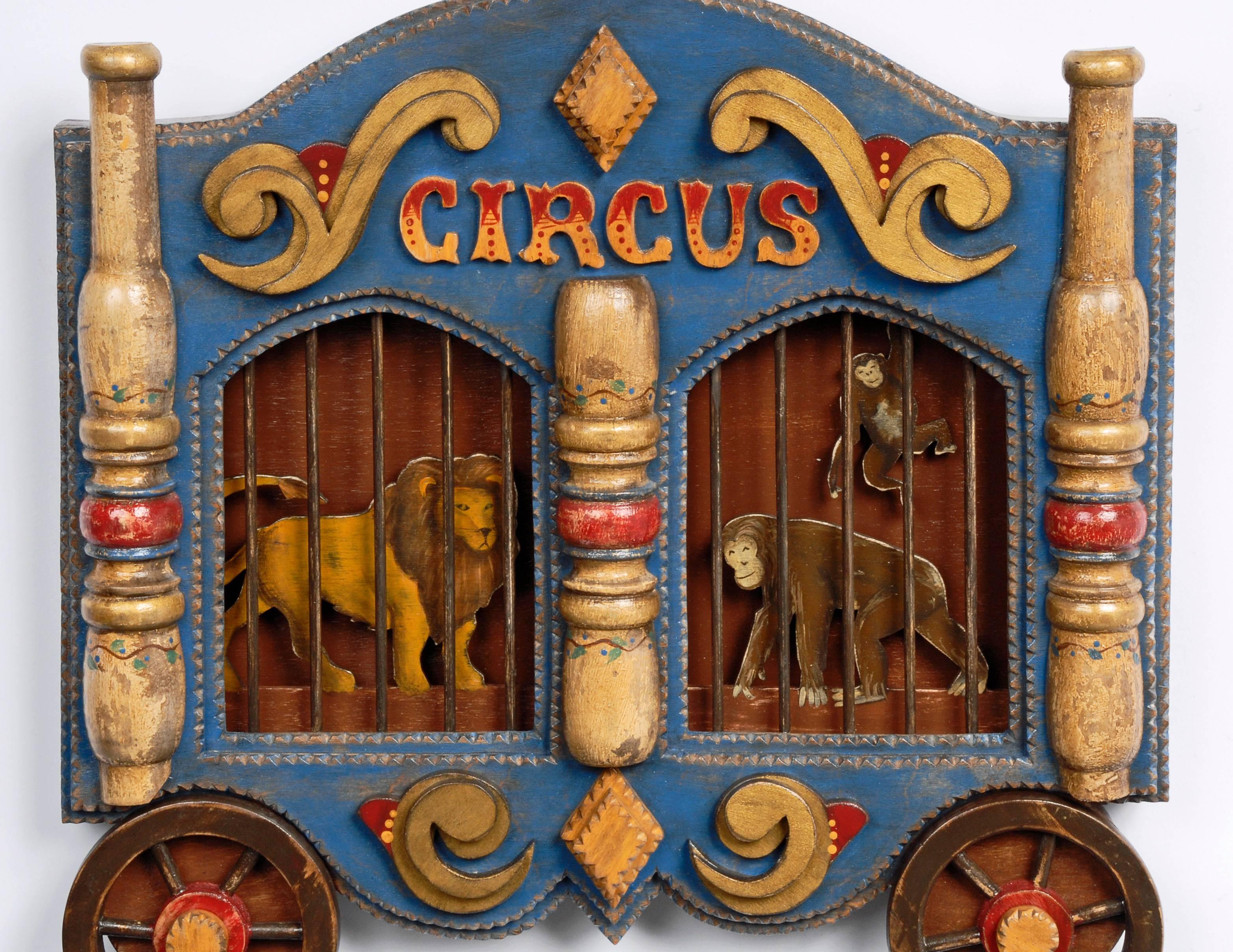 A whimsical Tramp Art 'Circus Wagon' frame with carved animals by contemporary artist Angie Dow.