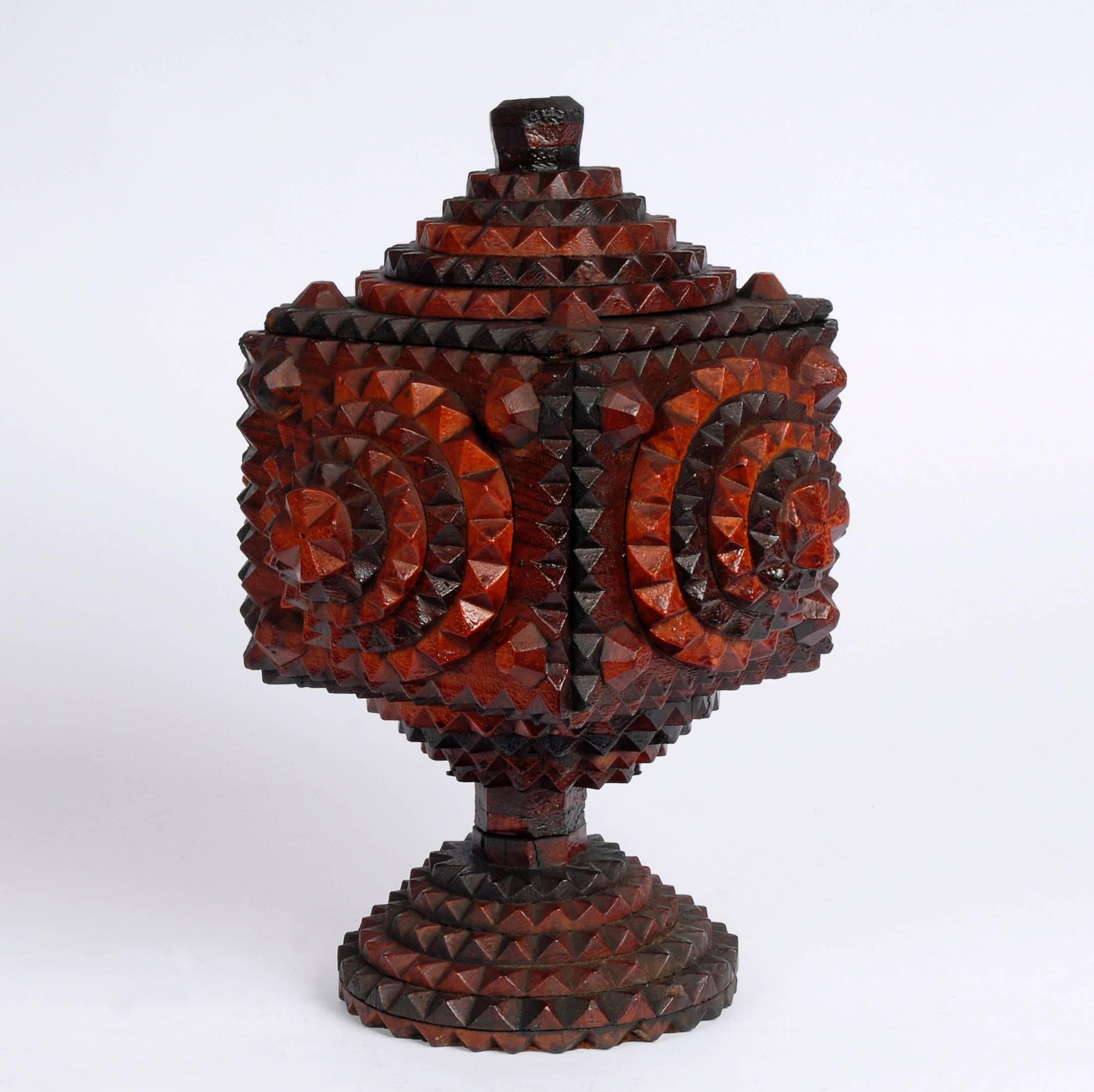 A lovely two-toned tramp art pedestal box with a hand carved finial on a round base. It has large layered rounds on all sides and on its top.

British Columbia
Circa 1920s