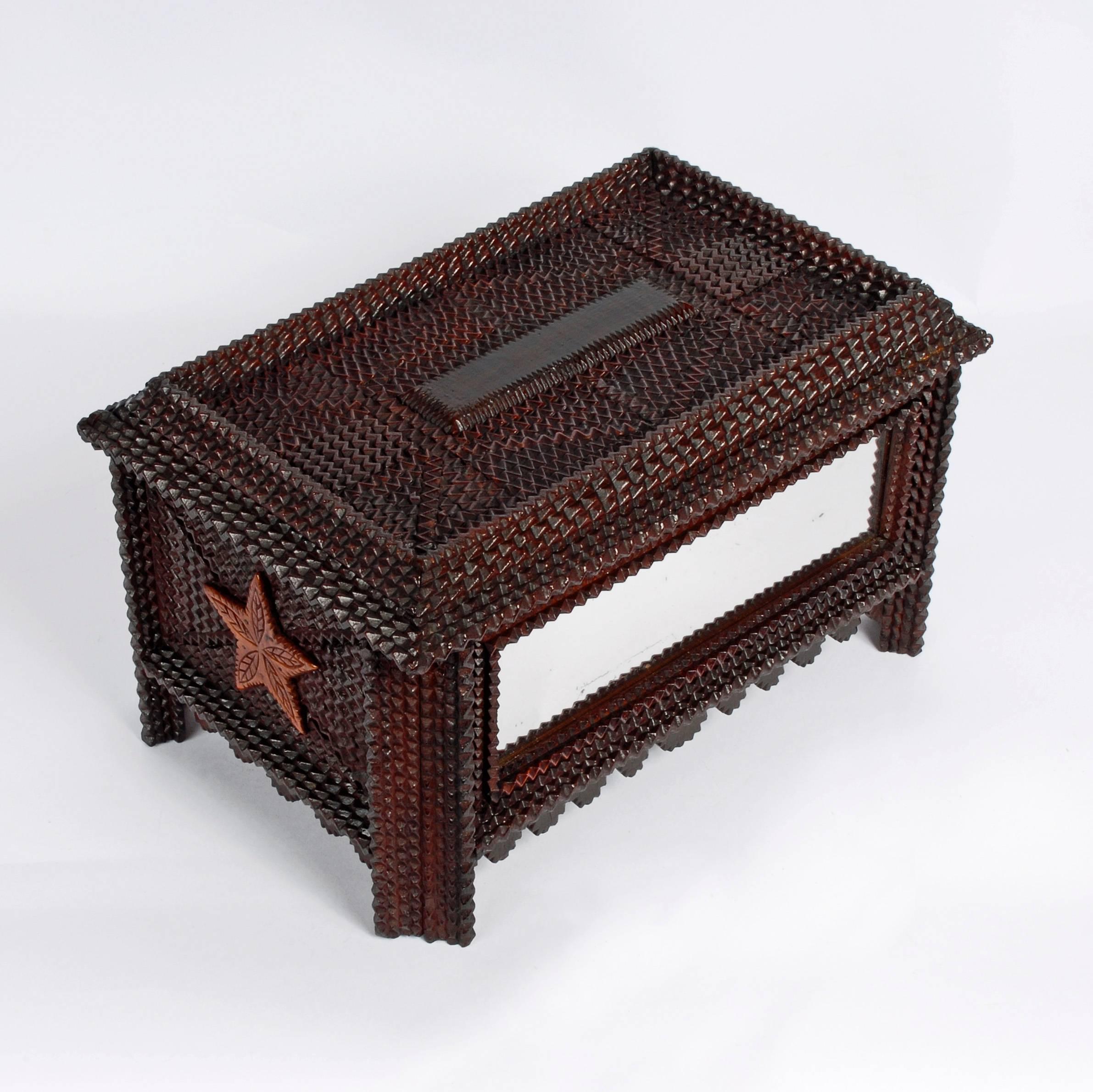 A superb Tramp Art box with a frontal inset mirror, edge scalloping, star ends and completely covered with a complex assemblage of strips of chip carved wood laid side by side termed flat mosaic work. There is a textile with a one word dedication,