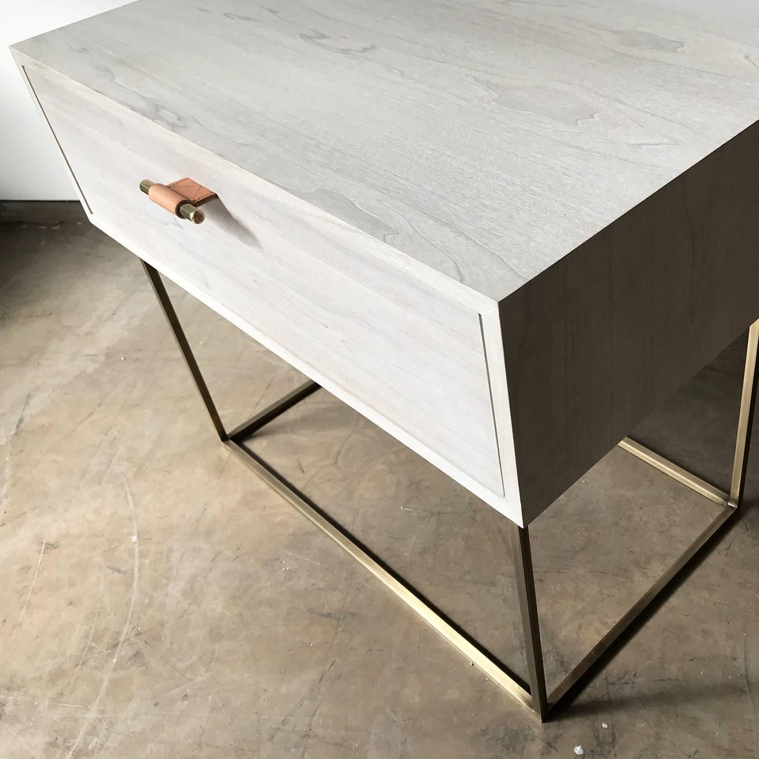 The Kerry side table by Thomas Hayes Studio features a custom wood case with a solid steel or brass base. The drawers are made with the highest quality soft-close mechanisms that open with our leather wrapped brass pulls. The Kerry is available in a
