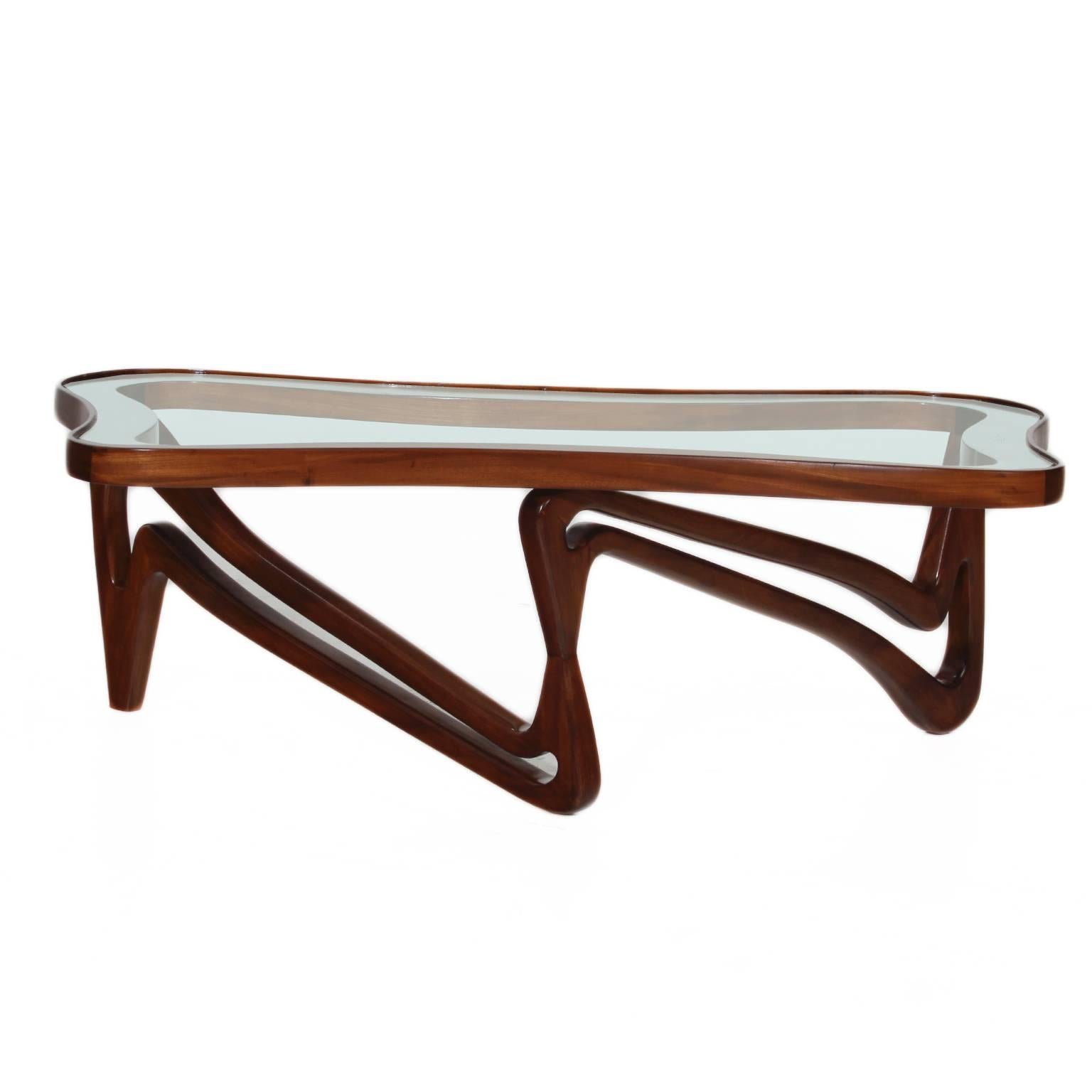 Beautiful solid Peroba de Rosa coffee table with square edges and sculptural base with an inset glass top, most likely designed by Giuseppe Scapinelli.

We have five unrestored tables, they can be available in a different finish. Please inquire if