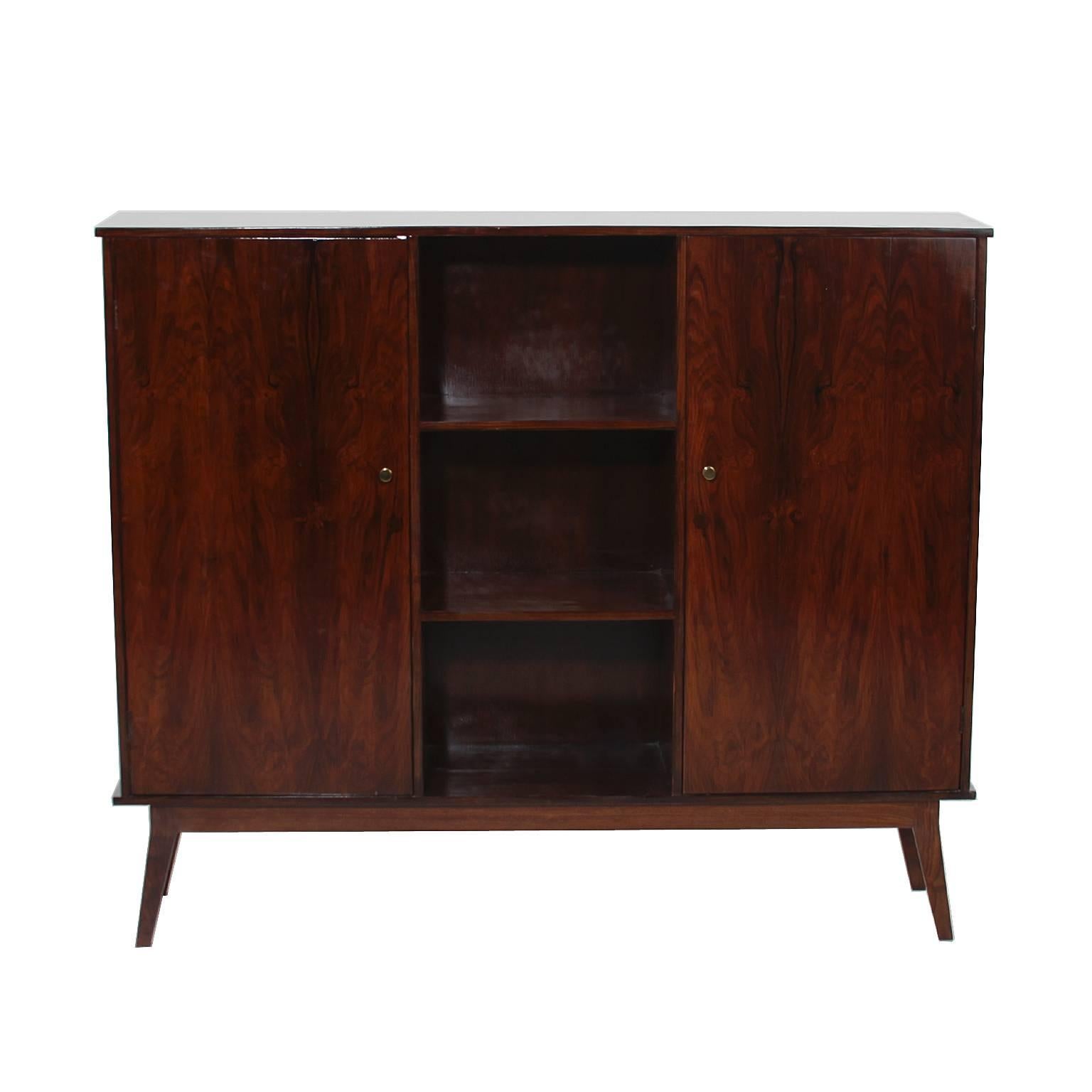 A vintage exotic hardwood cabinet from Brazil featuring several interior shelves and small brass handles.

 