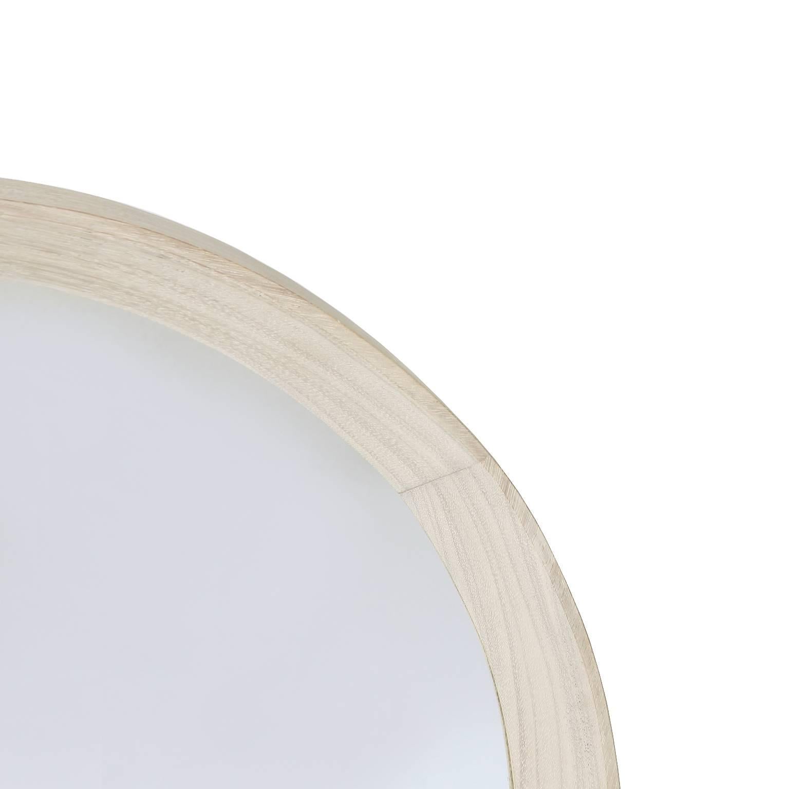 A round mirror from Brazil made of Imbuia with a bleached white oil finish. 

 