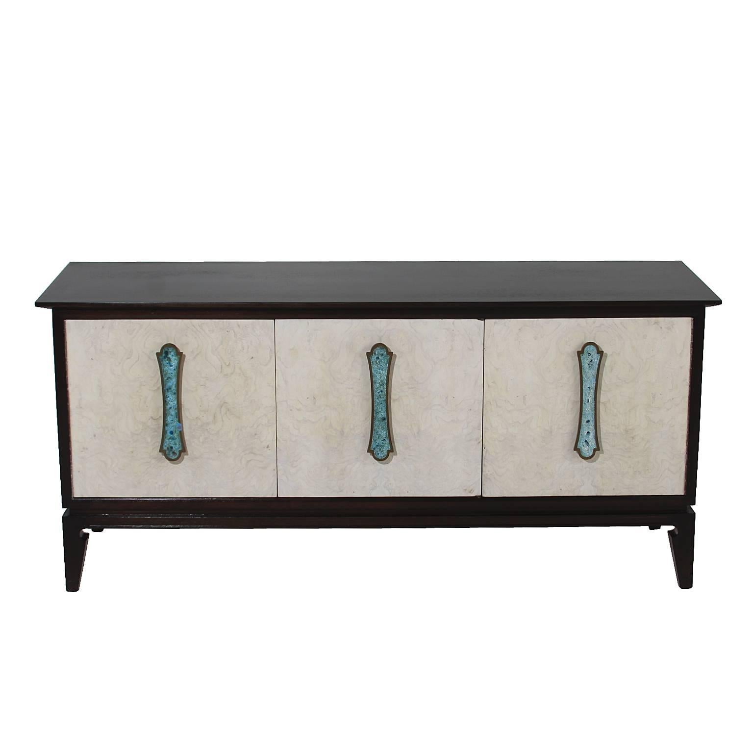 A Romweber credenza. The casing is original mahogany with a sheen finish. The door fronts have been refinished in a bleached and blanched oil. They are made of maple burl and have turquoise enameled handles by Harold Schwartz for Romweber. The first