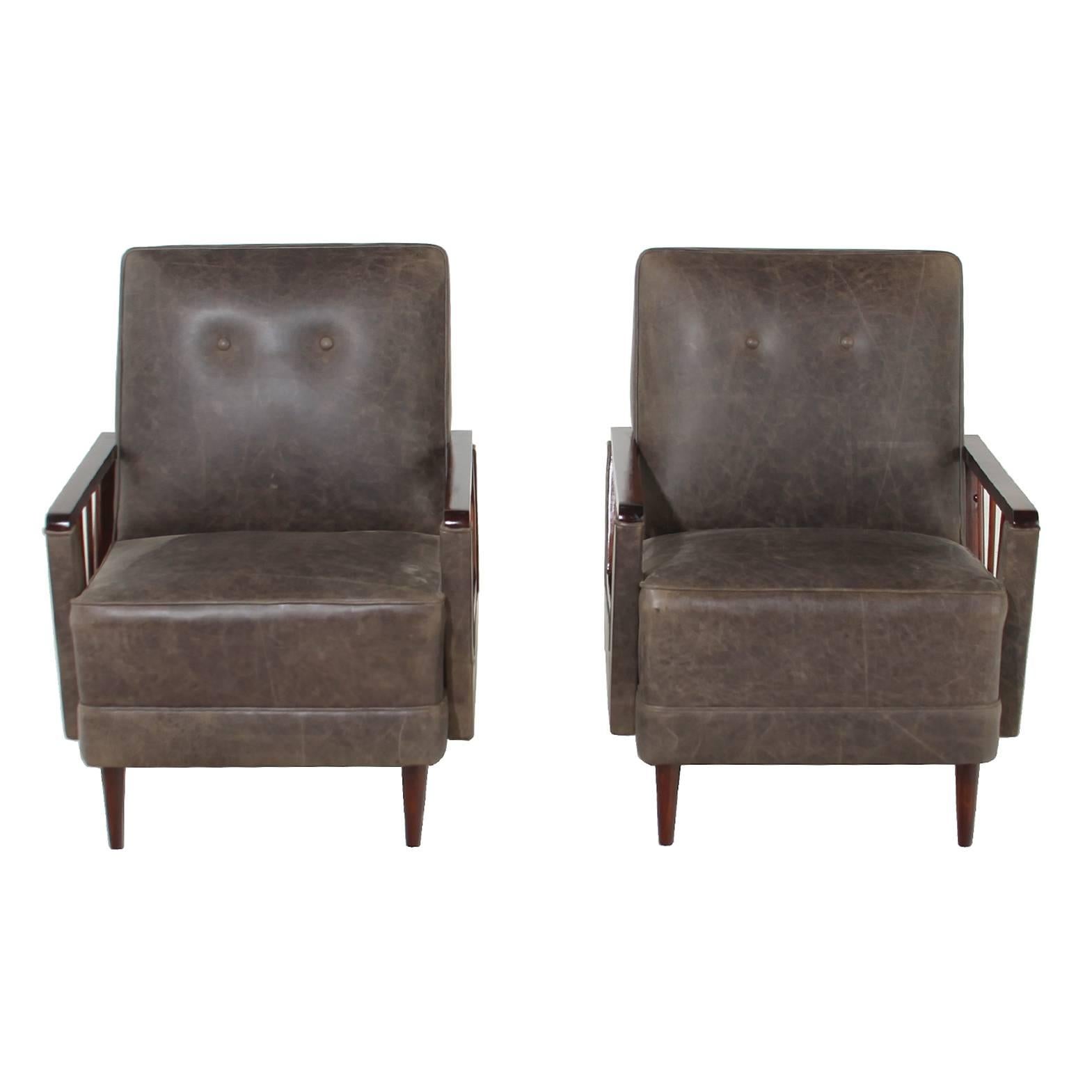 These two vintage rosewood armchairs are newly refinished in a medium satin lacquer with sleek conical legs and spindles. The piece is newly reupholstered in a textured brown leather with two buttons creating definition in the backrest.

Seat