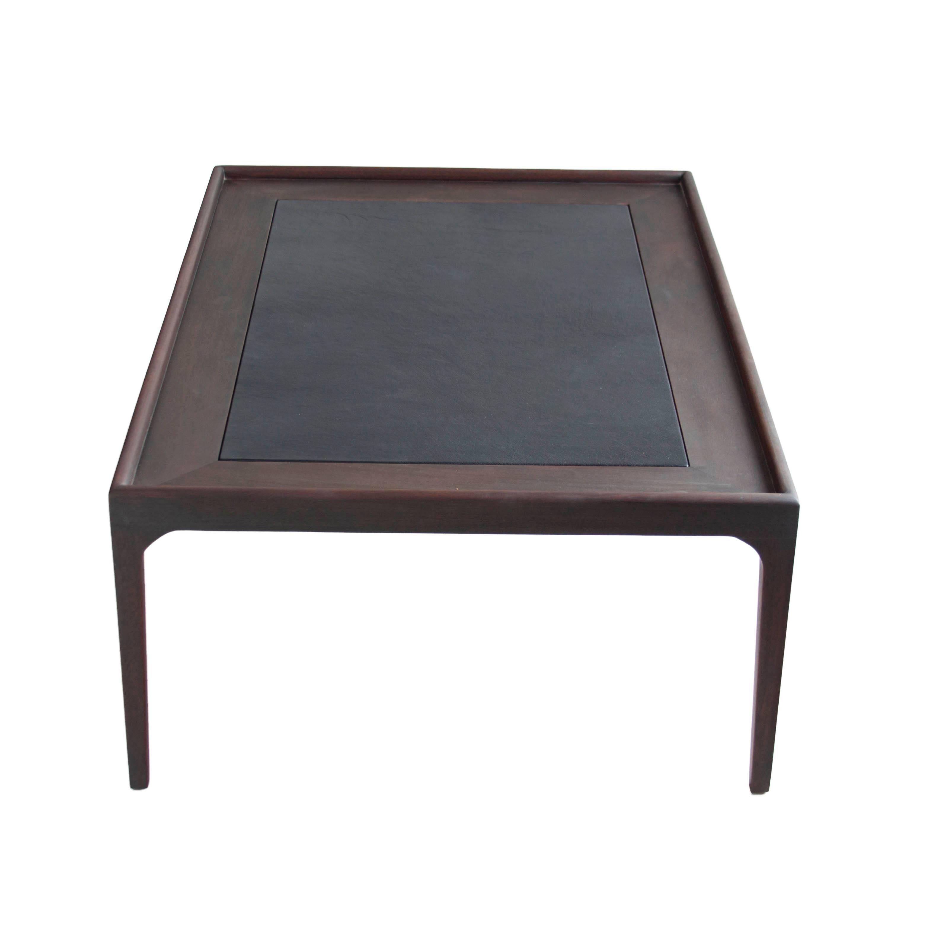 Beautifully restored Mid-Century mahogany coffee table with leather top.
