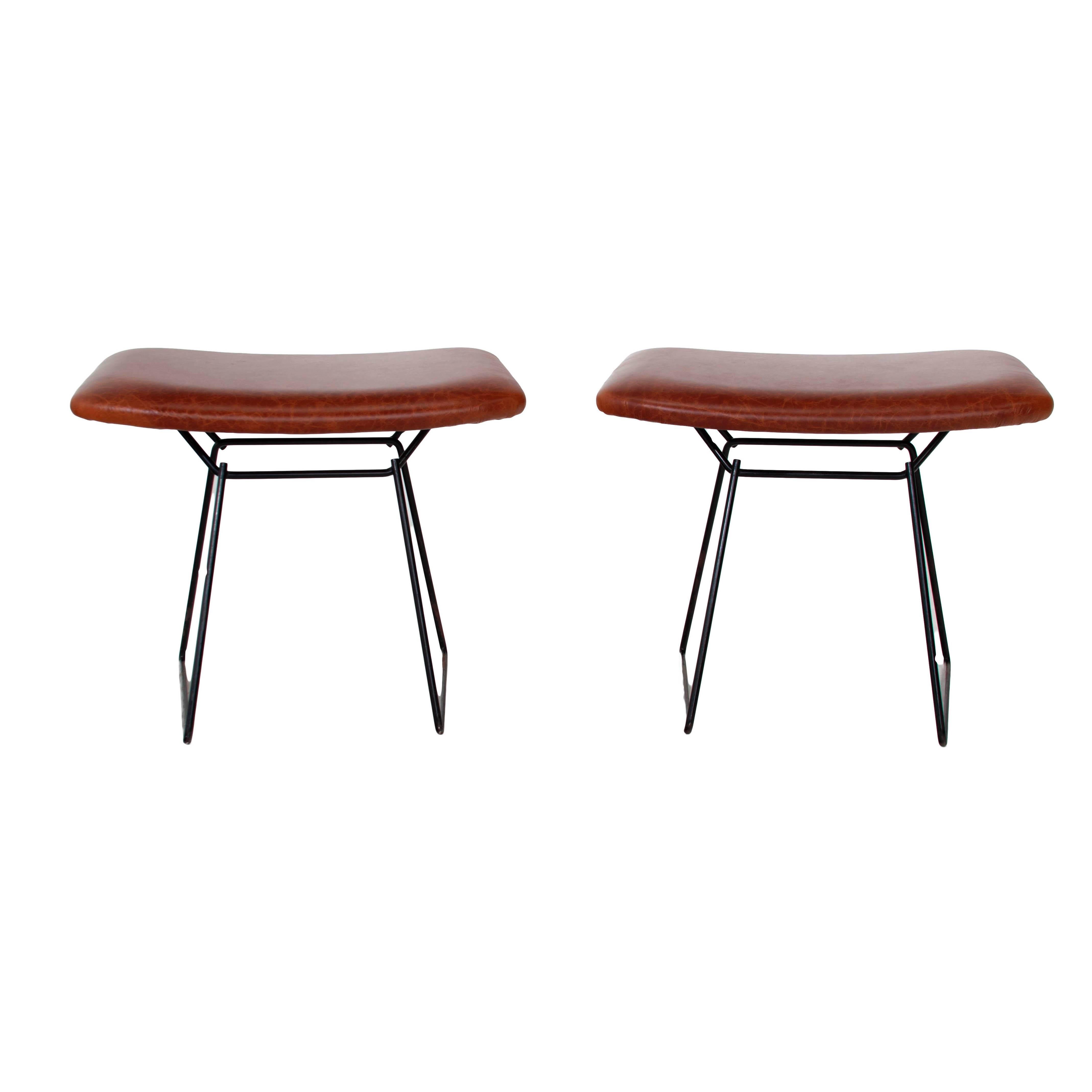 Restored Bertoia bird ottomans with distressed leather seats. Excellent as a pair of stools.Frames are in original condition, seats are newly constructed. 