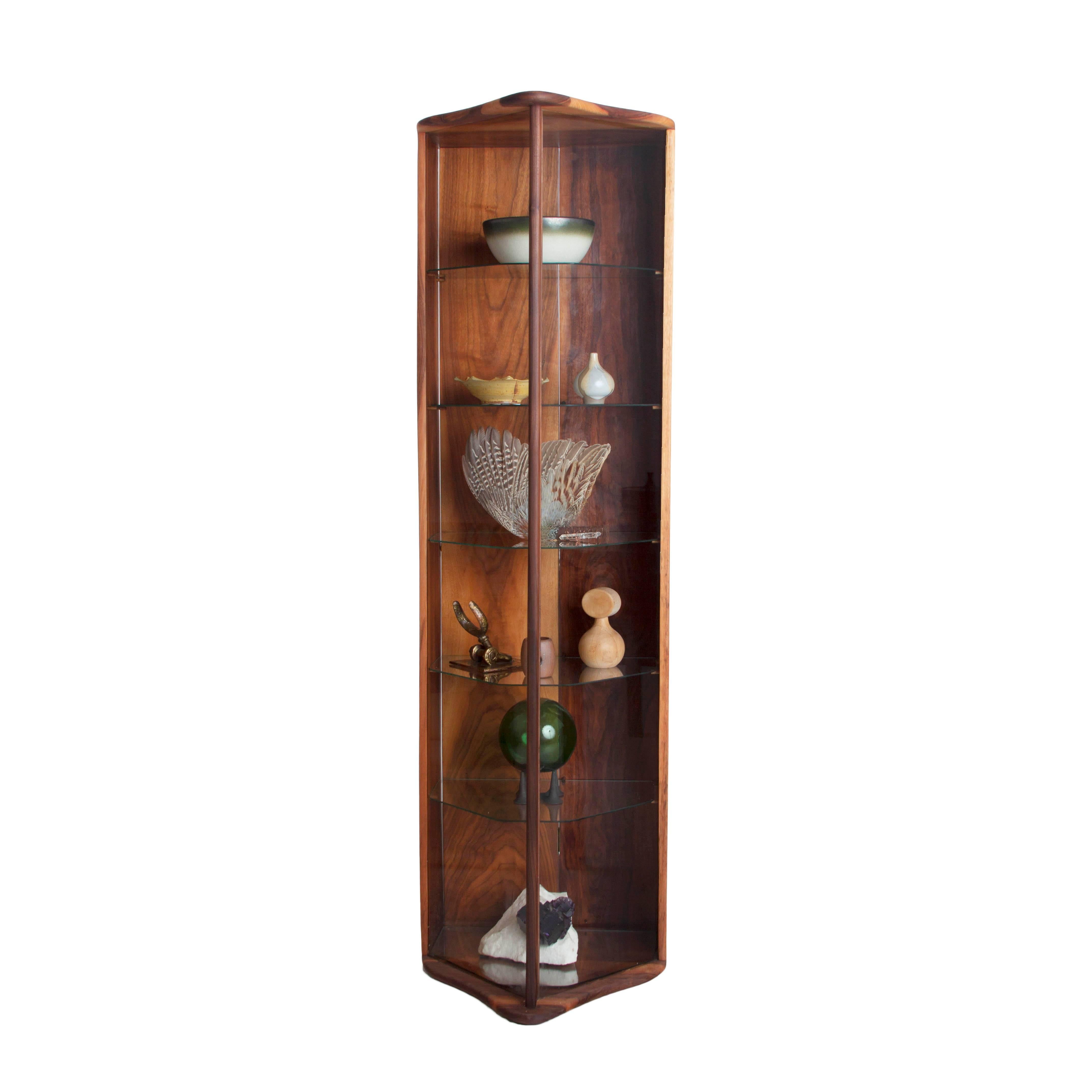 Elegant cabinet, exquisitely handcrafted from Walnut with six glass shelves. The design for the piece is simple yet genius. One back panel opens to access cabinet interior. Beautiful grain seen throughout. Period piece from the 1960's. Walnut has