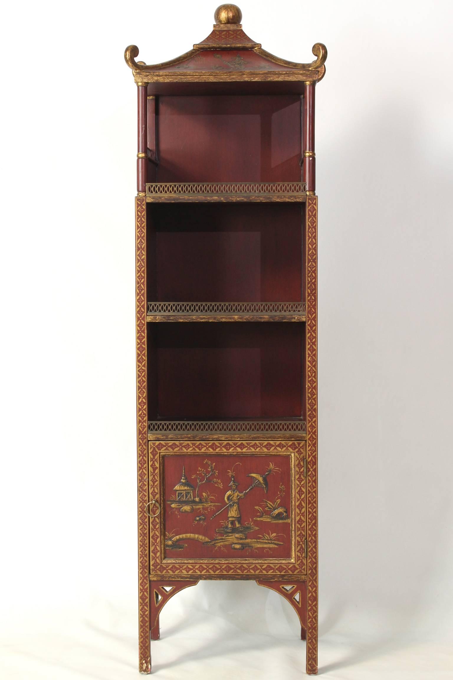A small and charming scarlet and gilt decorated chinoiserie, pagoda style bookcase with three open shelves and one small cupboard at the bottom of the piece.