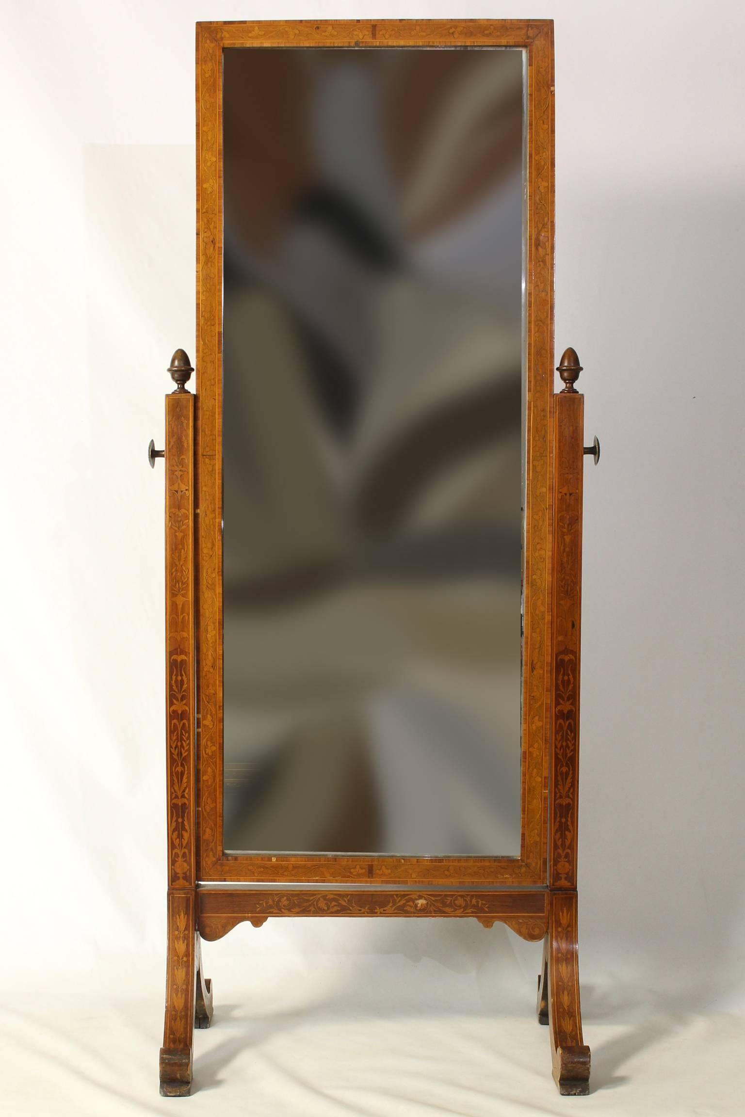 An elegant early 19th century Continental cheval mirror with foliate marquetry decoration throughout.