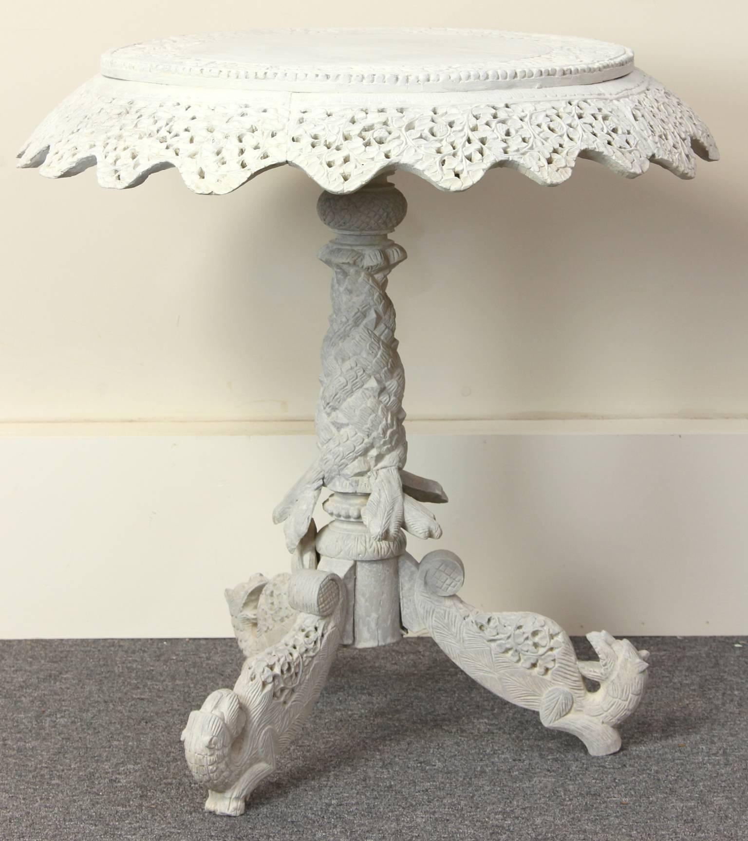 A charming late 19th century Anglo-Indian elaborately carved side table painted overall in a soft gray palette.